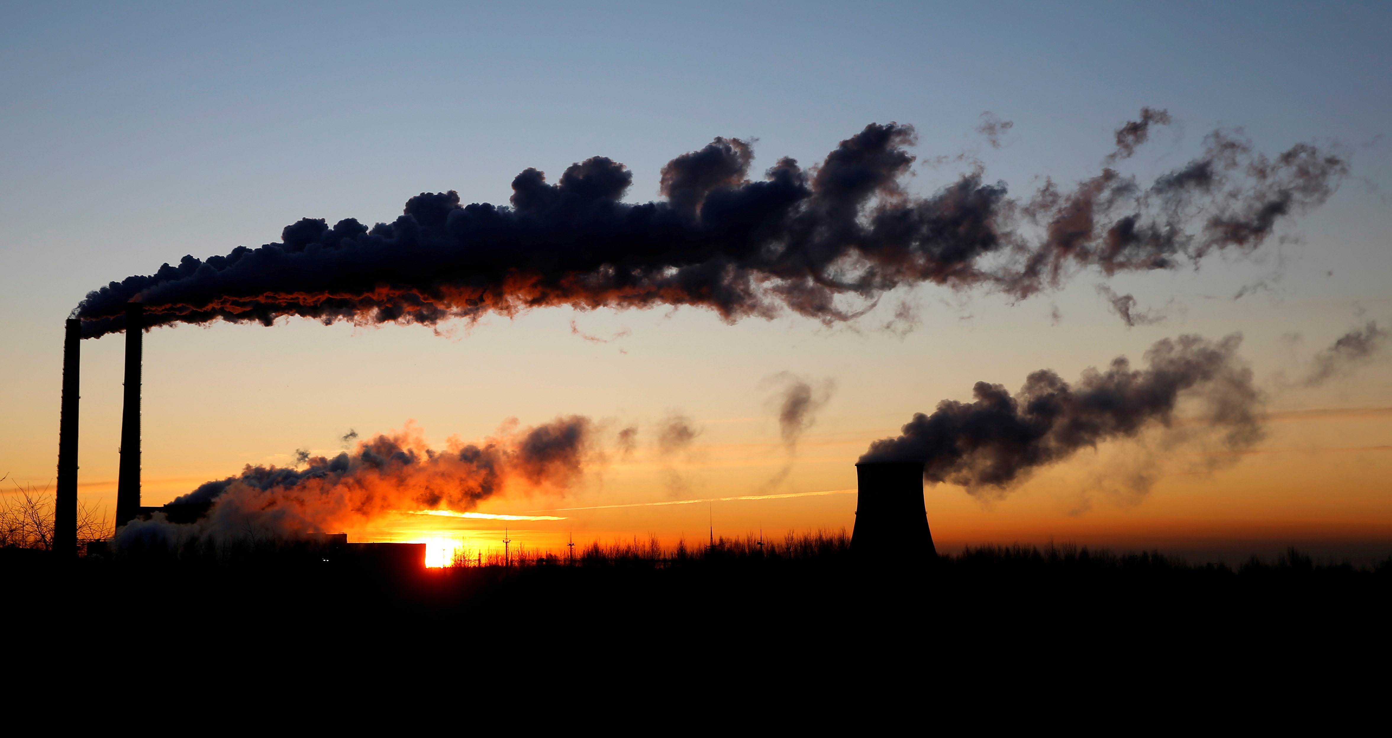 Sun rises behind a gas-fired power station in Minsk