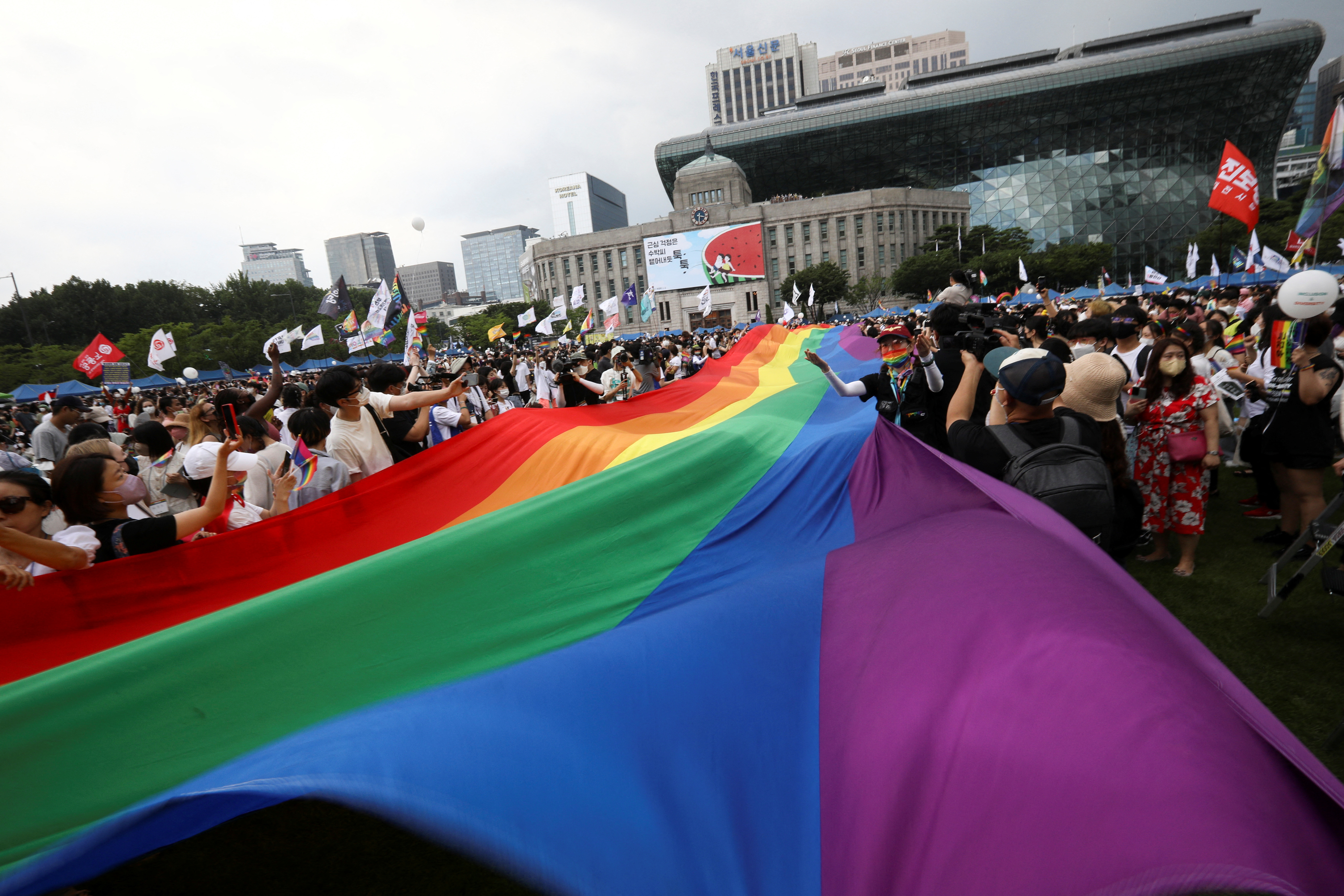 Participants wave rainbow flags during the Korea Queer Culture Festival 2022 in central Seoul
