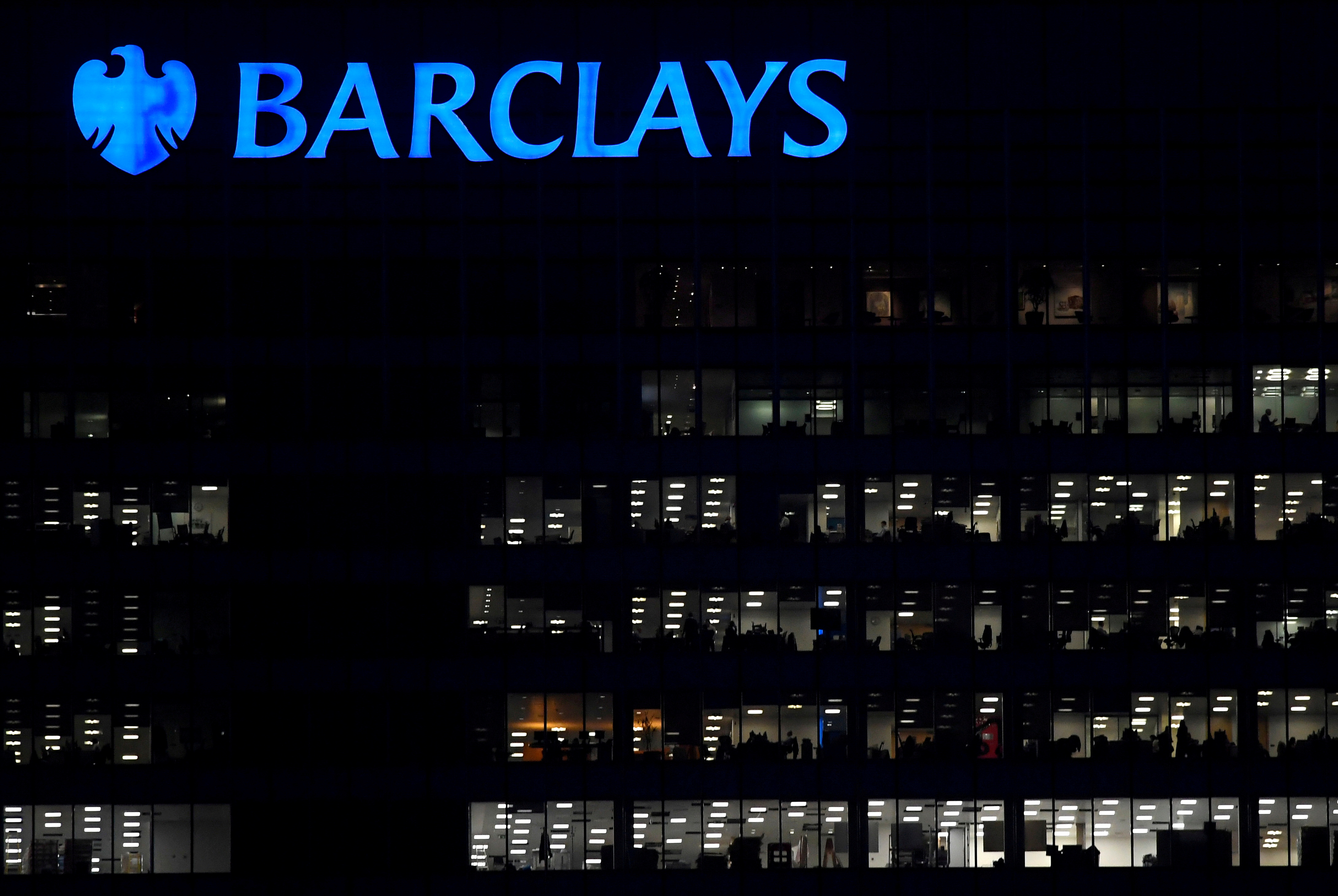 Workers are seen at Barclays bank offices in the Canary Wharf financial district in London