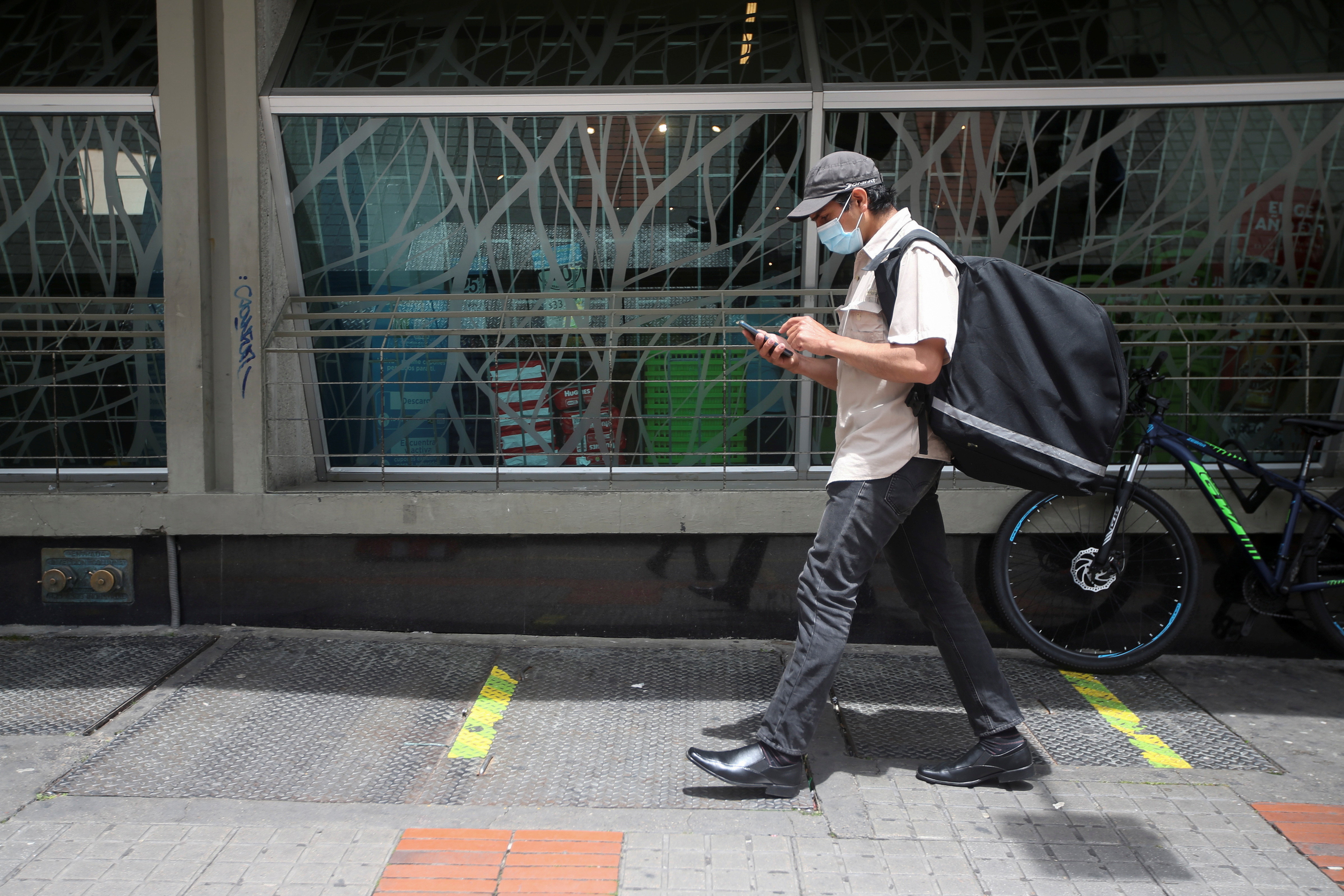 Pablo Toro, Venezuelan delivery worker uses the Valiu app from his cell phone in Bogota, Colombia June 15, 2021. Picture taken June 15, 2021. REUTERS/Luisa Gonzalez