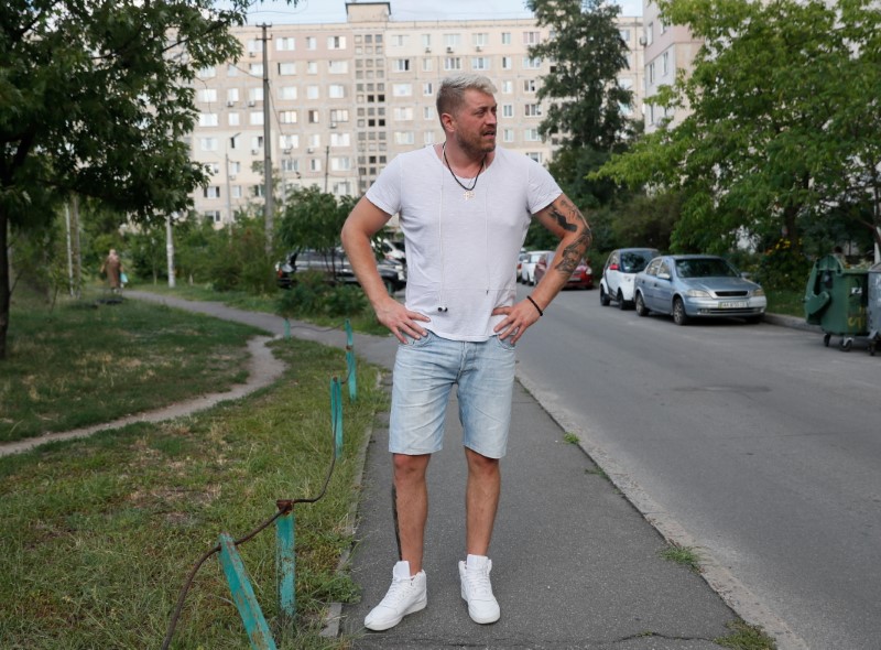 Konstantin Yakovlev, a 36-year-old Belarusian handball coach, stands on a street in Kyiv