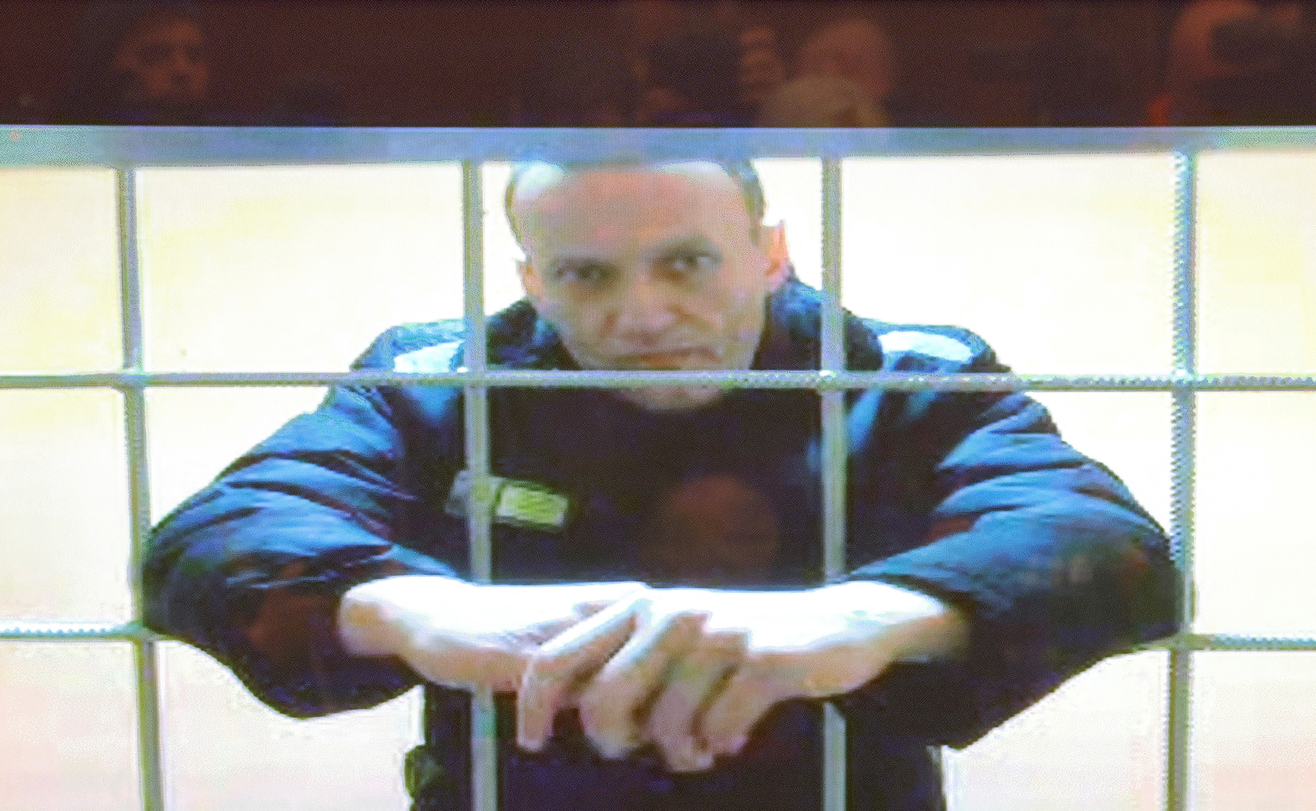 Jailed Russian opposition leader Alexei Navalny is seen on a screen during a court hearing in Moscow