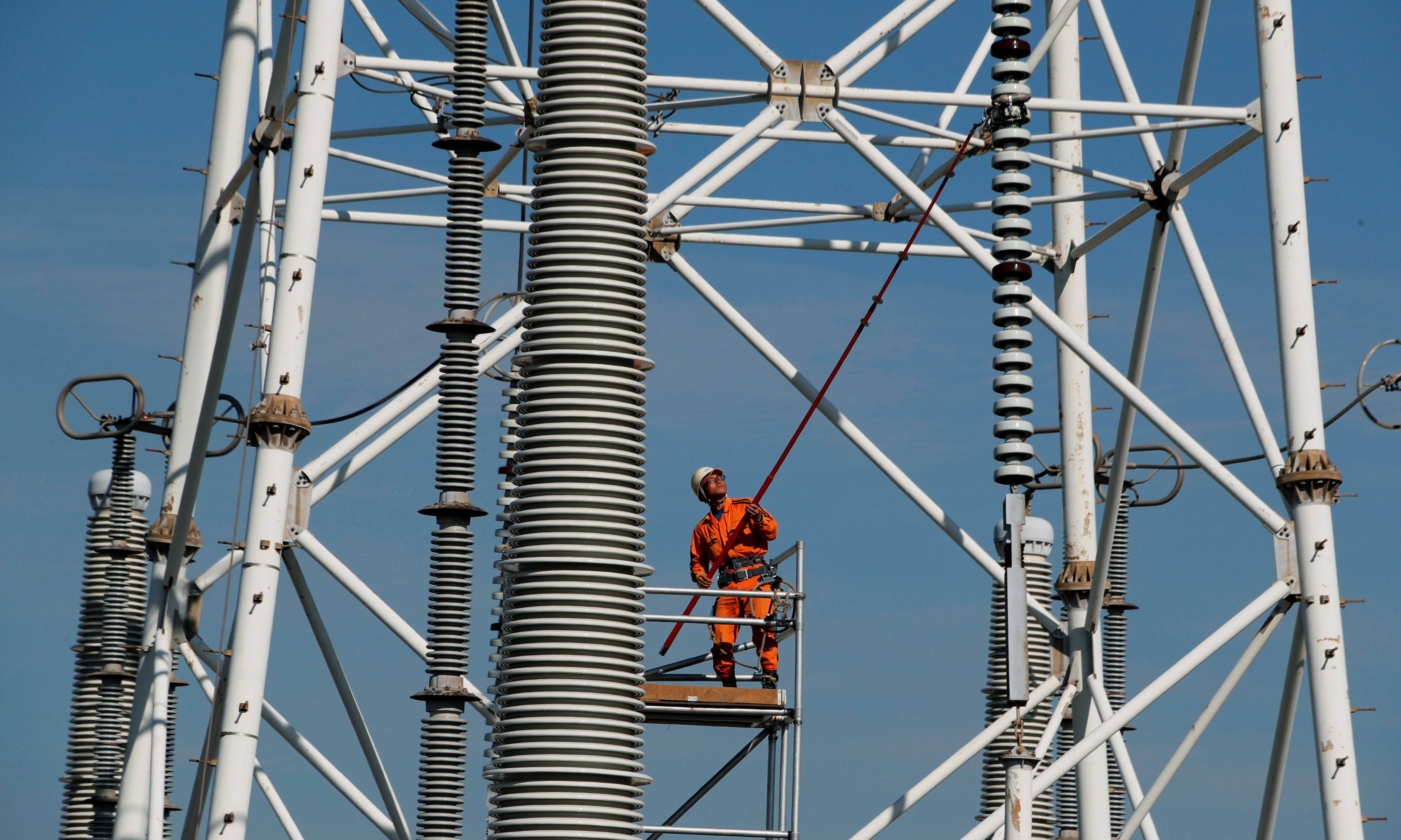 A man works at a transmission tower in Kakogawa