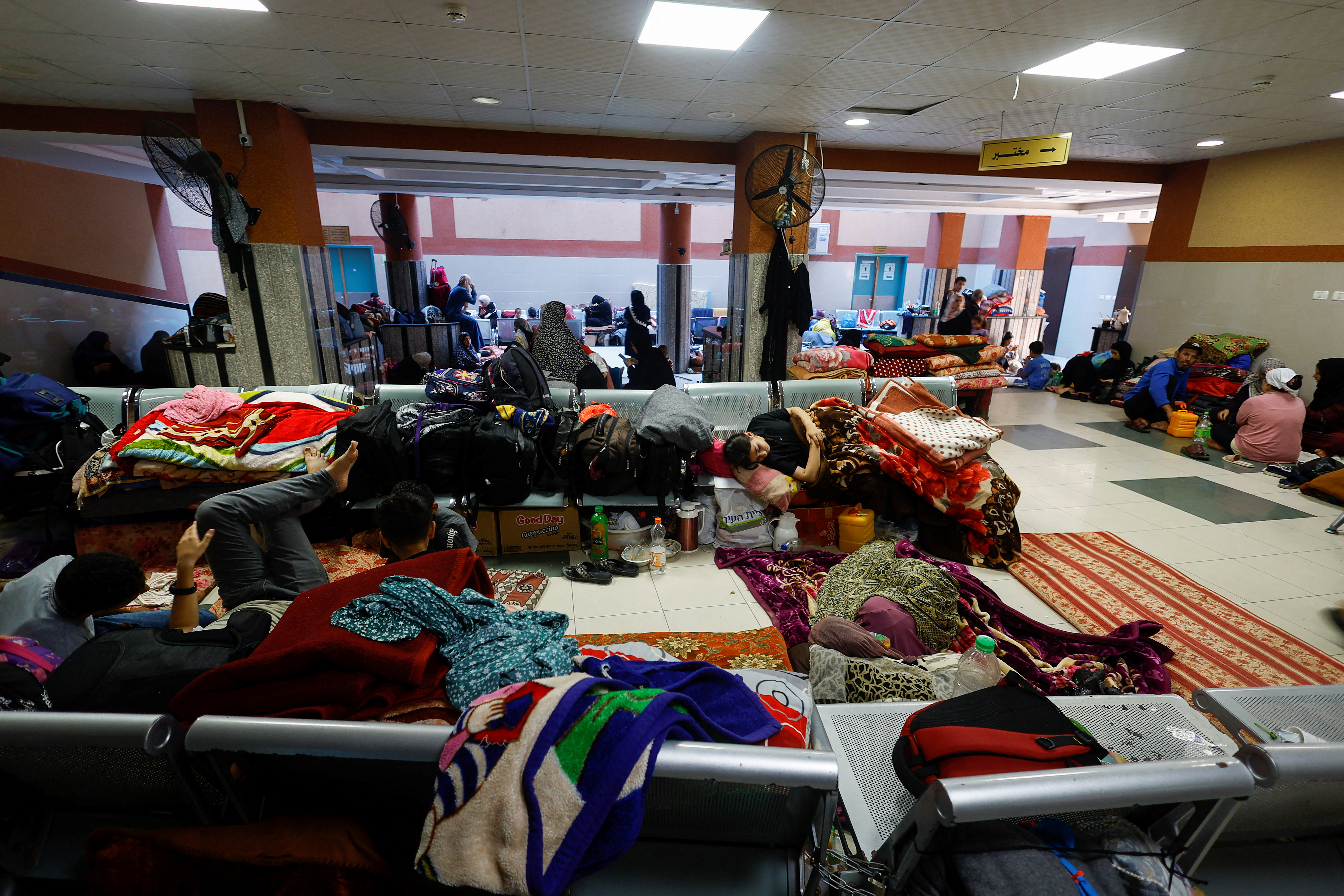 Displaced Palestinians, who fled their homes amid Israeli strikes, take shelter at Nasser hospital, in Khan Younis