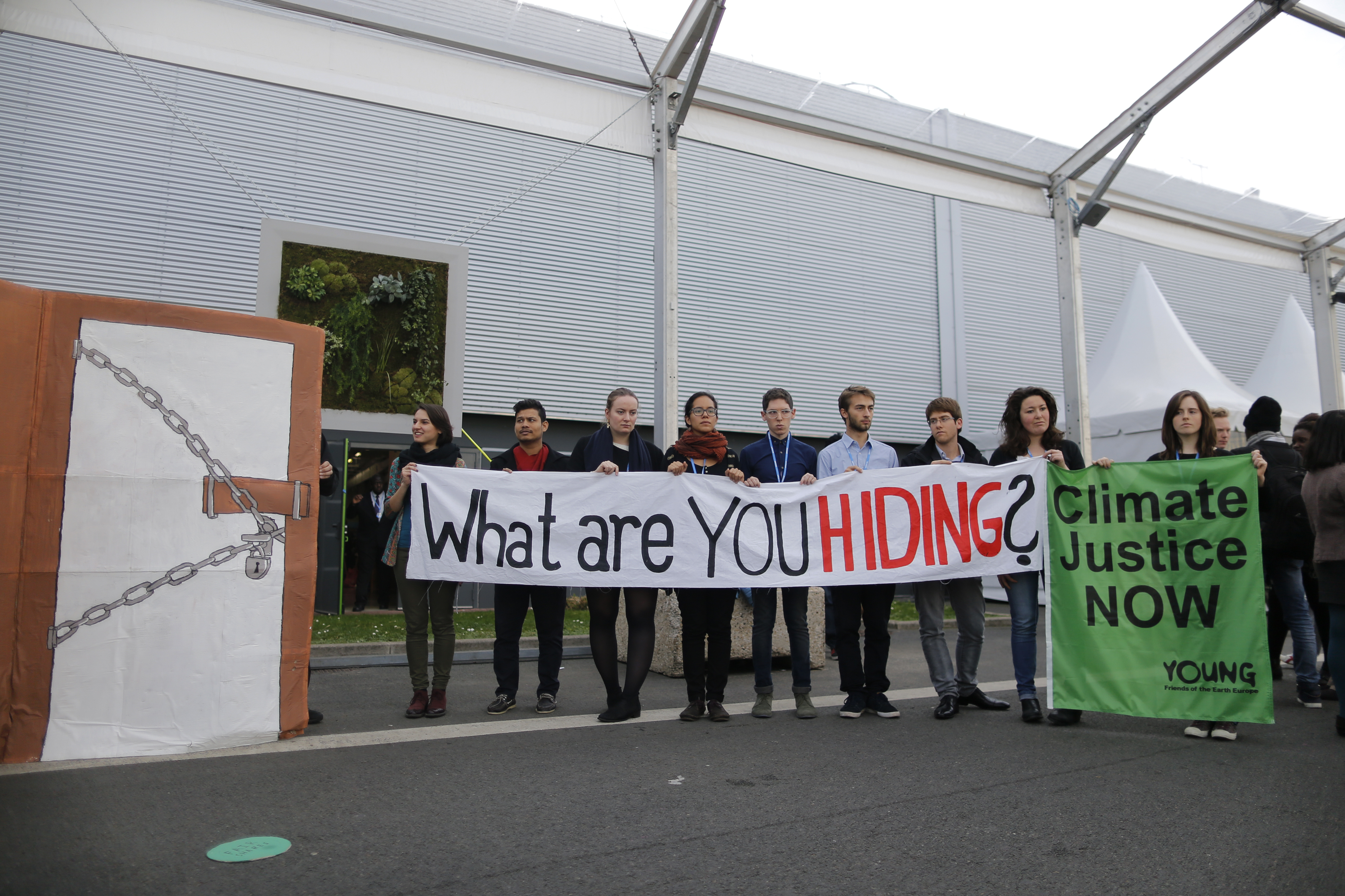 Members of Young Friends of the Earth Europe demonstrate during the World Climate Change Conference 2015 at Le Bourget