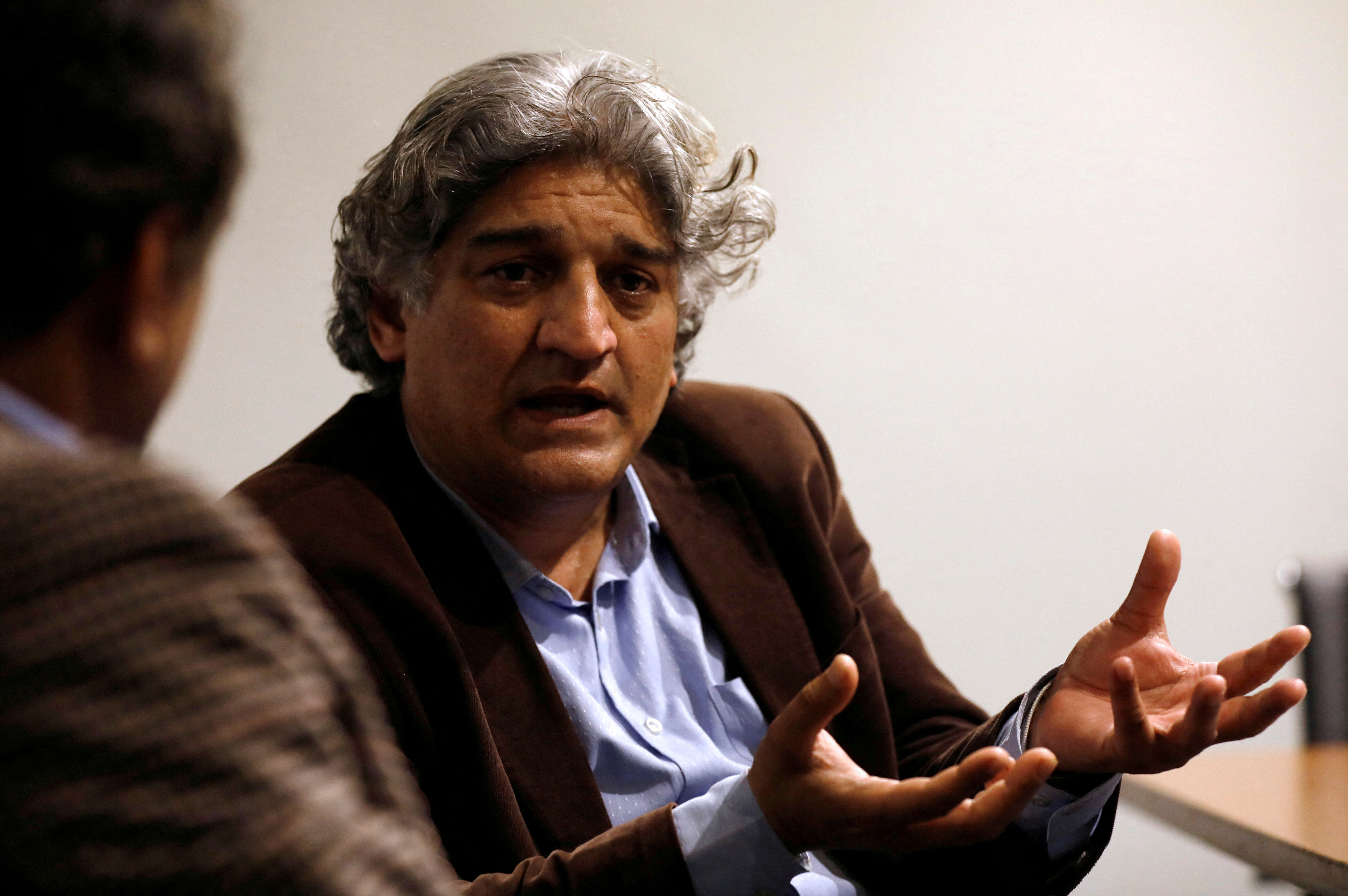 Matiullah Jan, a journalist and columnist, gestures during an interview with Reuters at his office in Islamabad