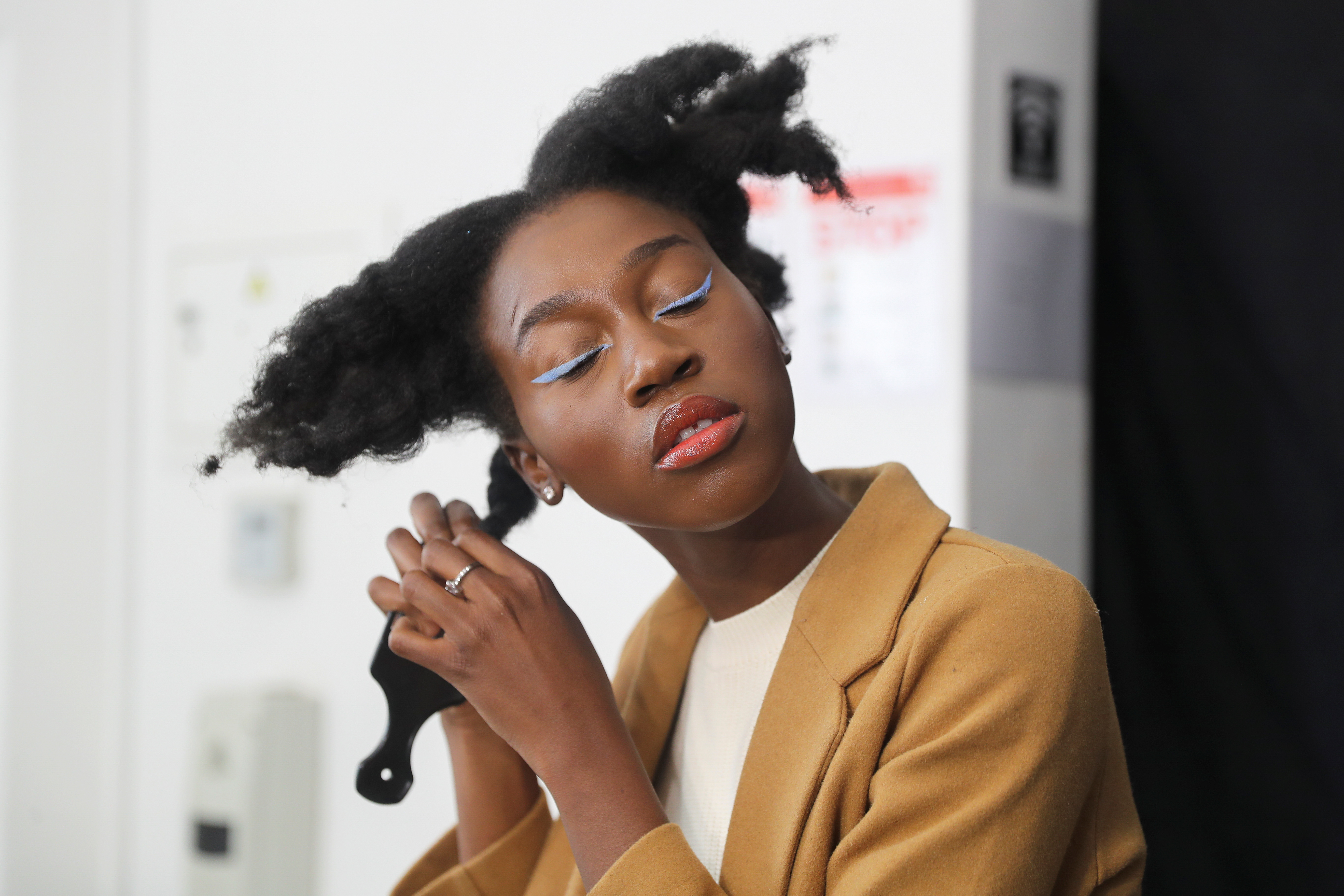 Lehlogonolo Machaba, the first openly transgender woman to compete for the Miss South Africa title combs her hair before a photo shoot in Johannesburg
