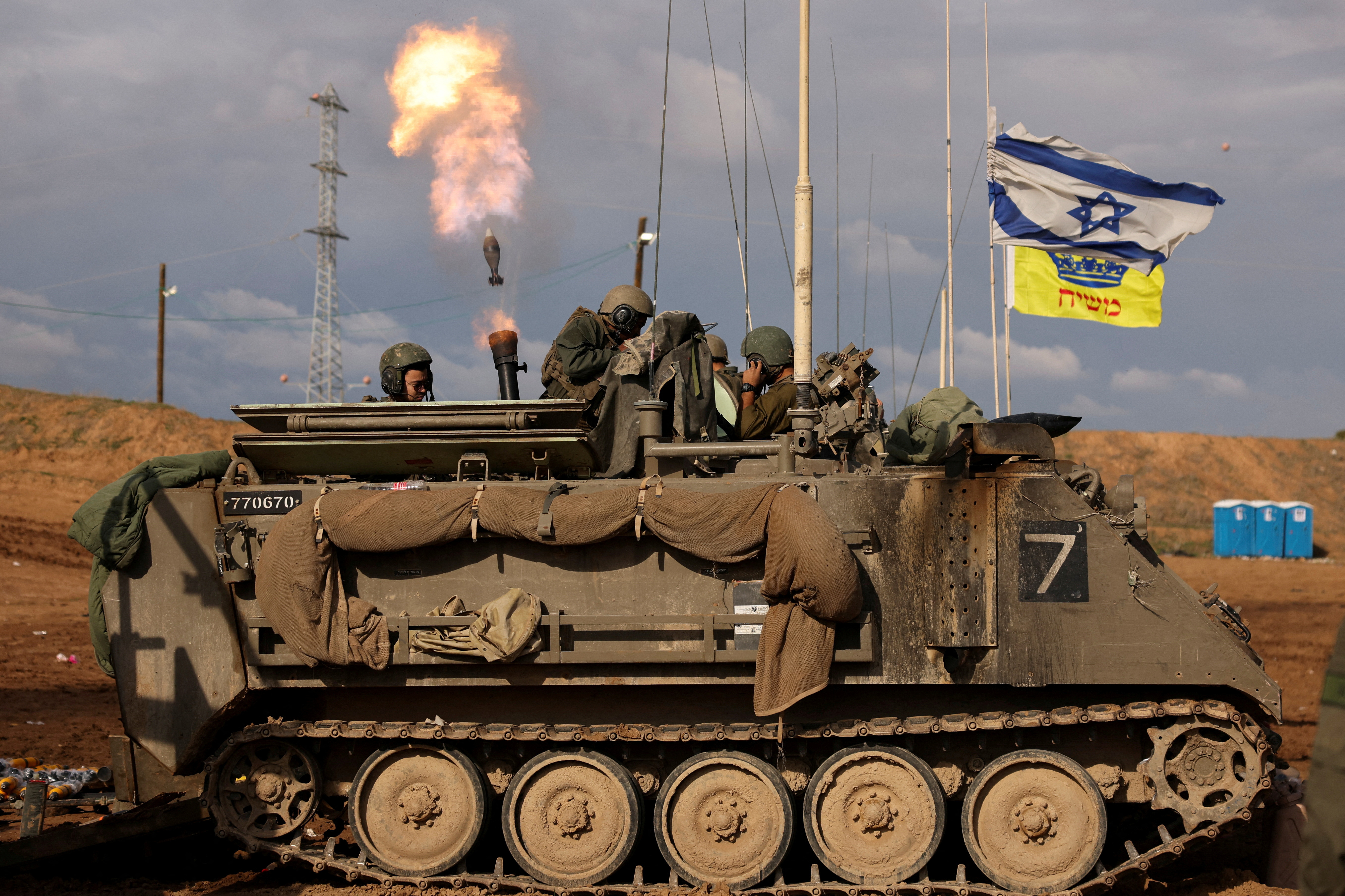 Israeli soldiers fire mortar shells near Israel's border with Gaza in southern Israel