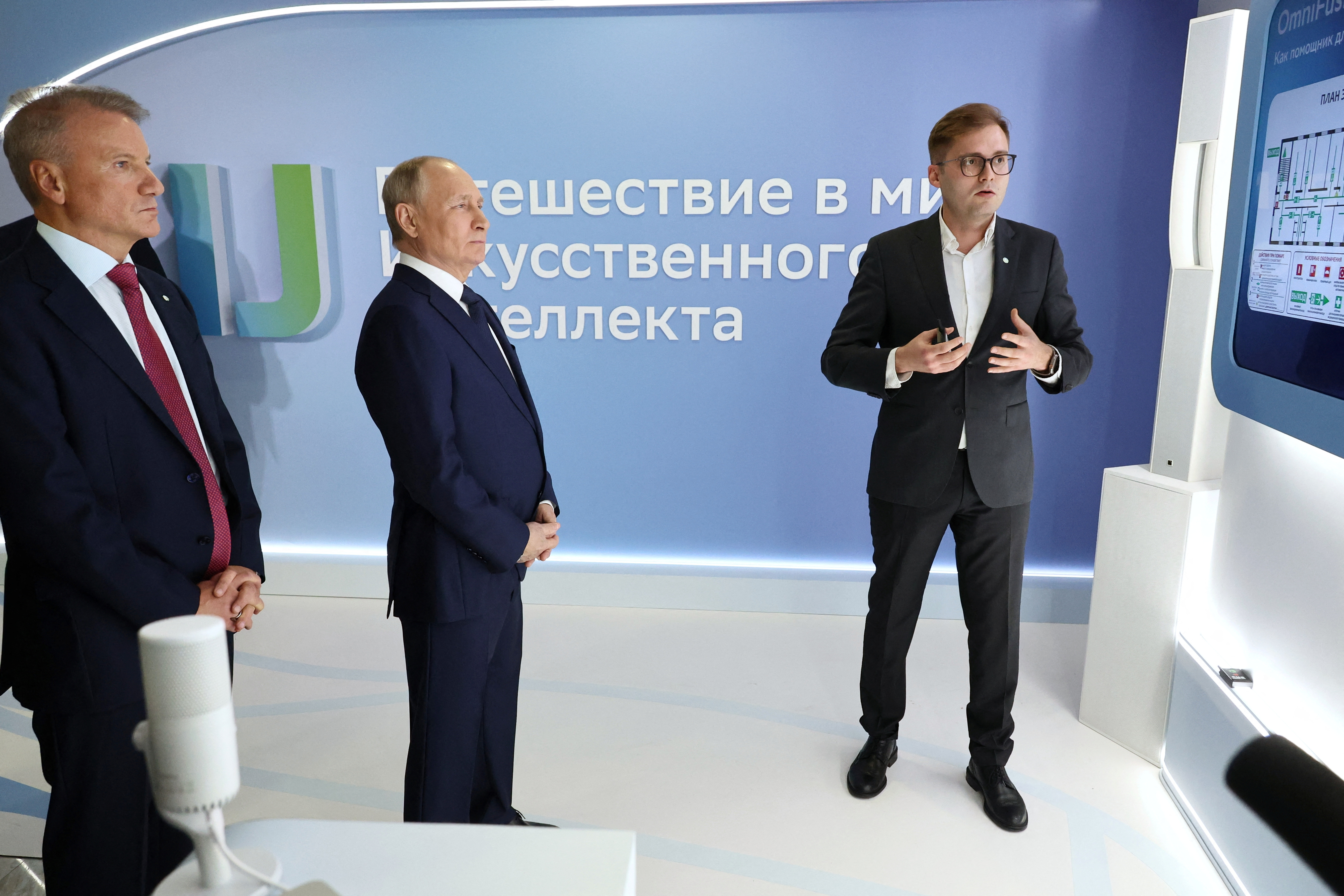Russian President Vladimir Putin, accompanied by Sberbank CEO and Chairman of the Executive Board German Gref, tours an exhibition as part of the AI Journey 2023, an international artificial intelligence conference, in Moscow, Russia November 24, 2023. Sputnik/Mikhail Klimentyev/Kremlin via REUTERS