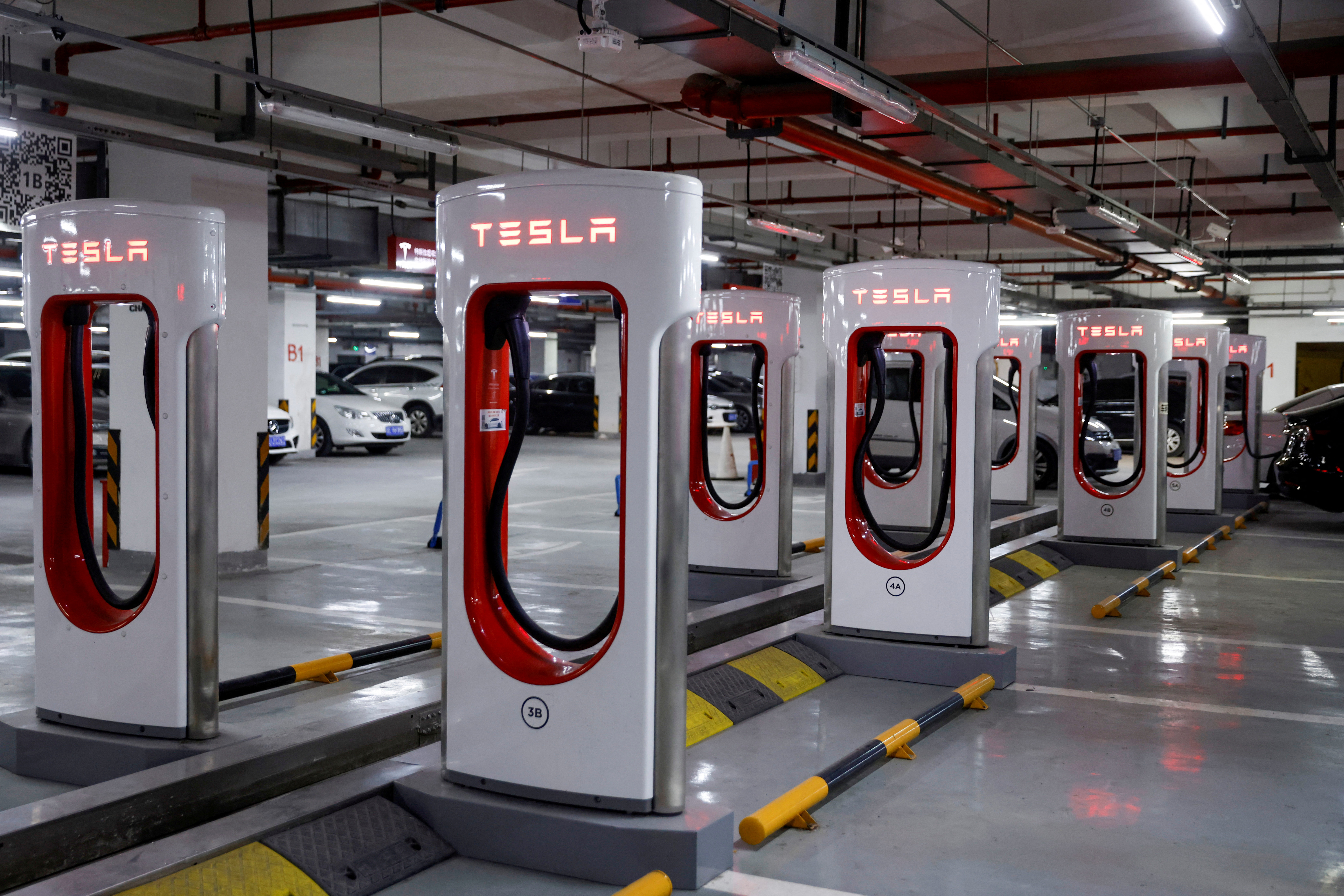 Tesla charging stations are pictured in a parking lot in Shanghai