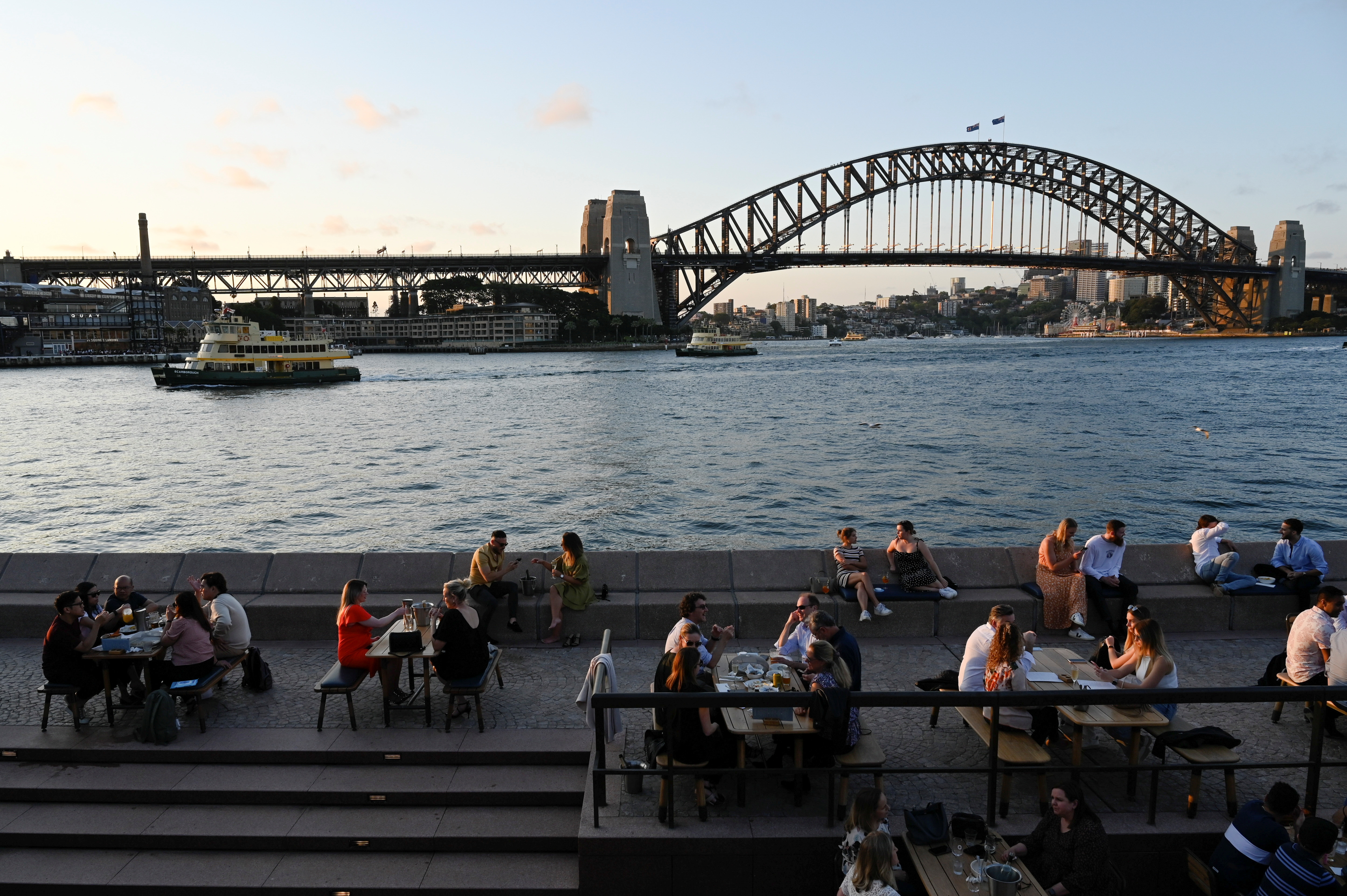 Patrons dine-in at a bar by the harbour in the wake of coronavirus disease (COVID-19) regulations easing, following an extended lockdown to curb an outbreak, in Sydney, Australia, October 22, 2021. REUTERS/Jaimi Joy
