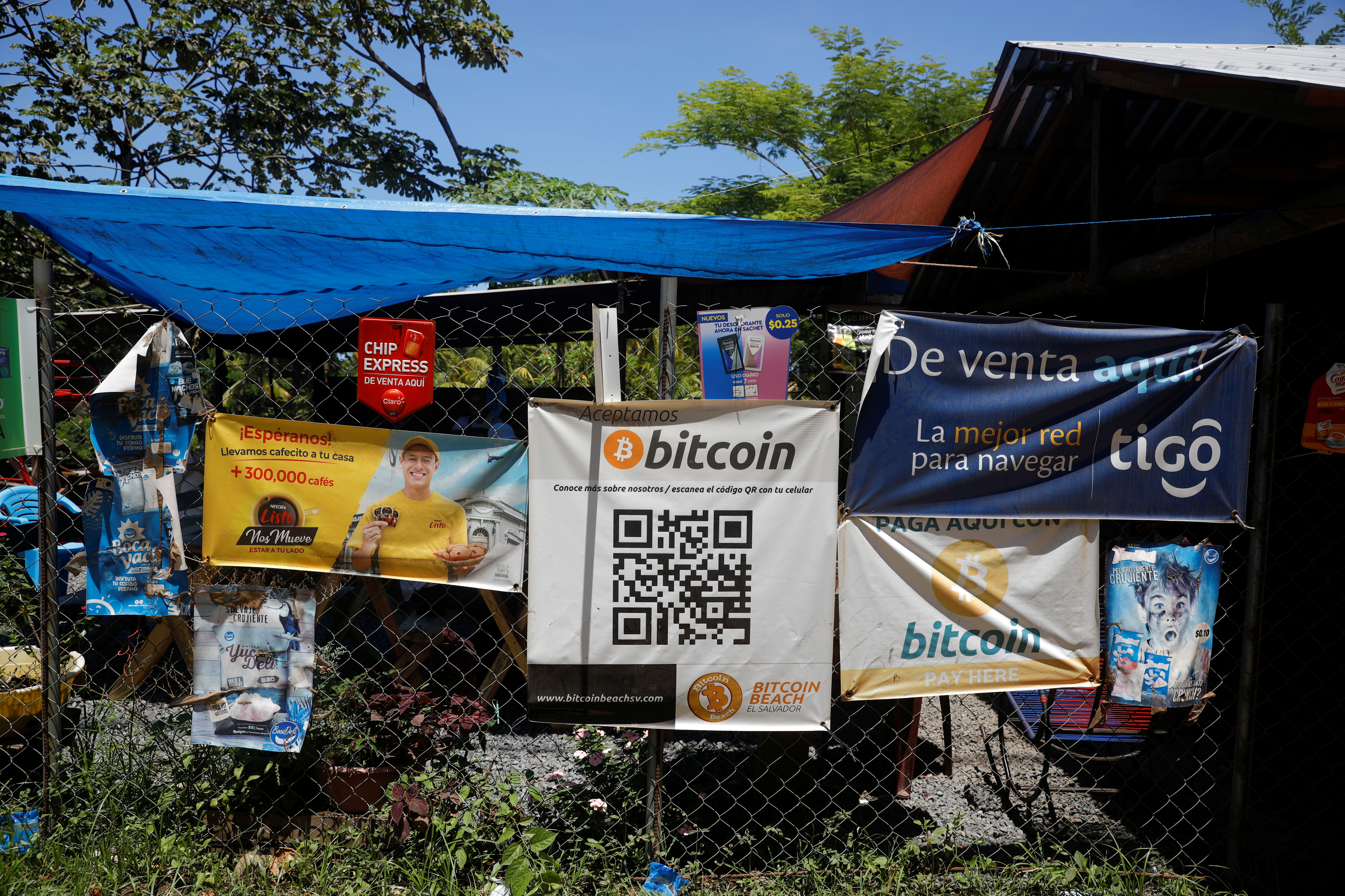 Bitcoin banners are seen outside of a small restaurant at El Zonte Beach in Chiltiupan, El Salvador June 8, 2021. REUTERS/Jose Cabezas/File Photo