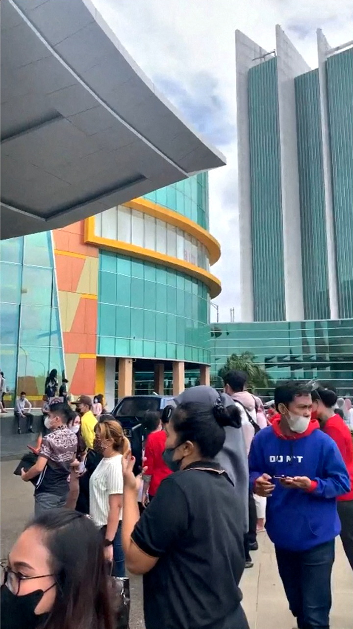 A still image from a social media video shows people standing outside a mall after an earthquake in Makassar, Indonesia