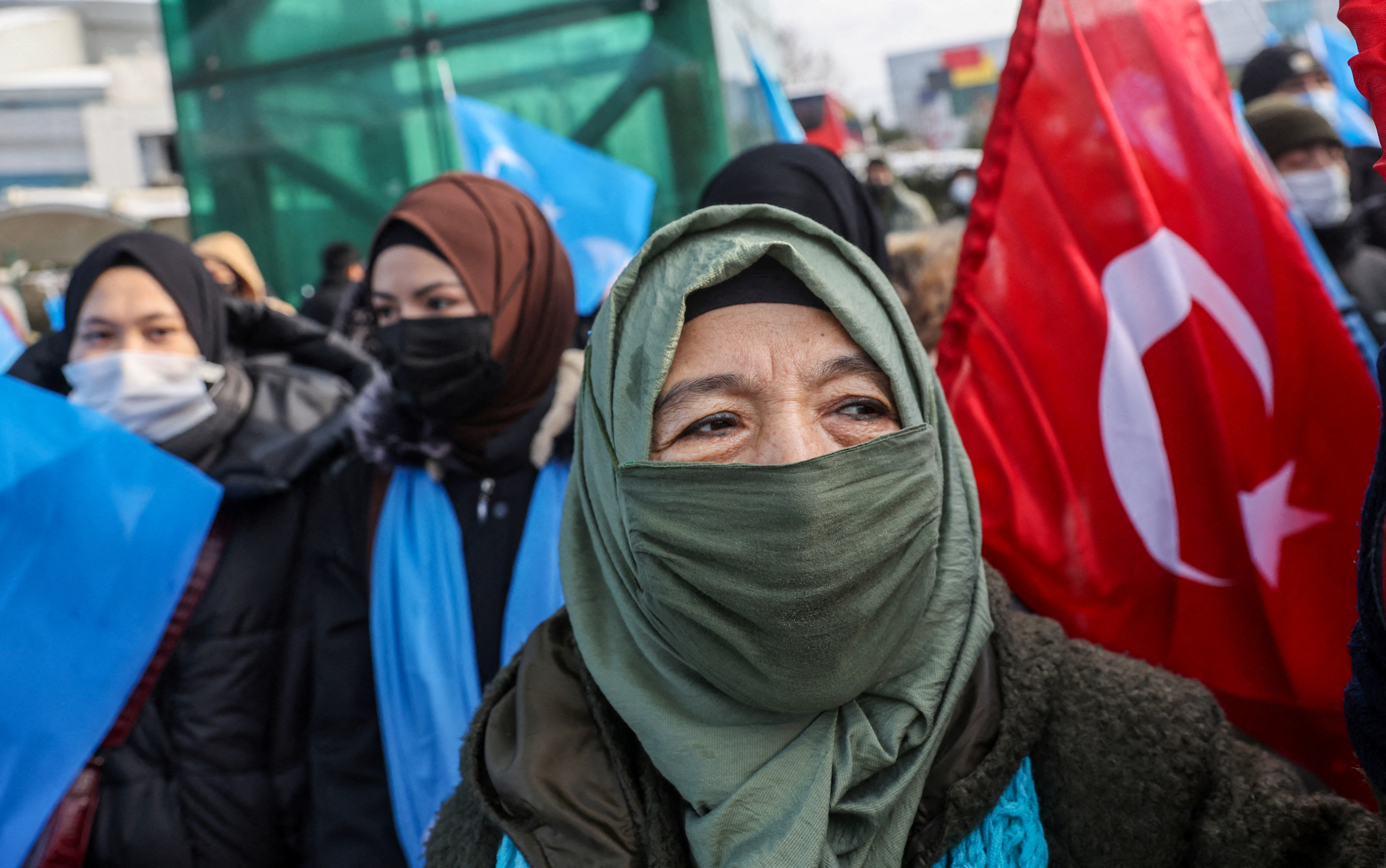 People from China's Uyghur Muslim ethnic group protest outside the city's Turkish Olympic Committee building in Istanbul