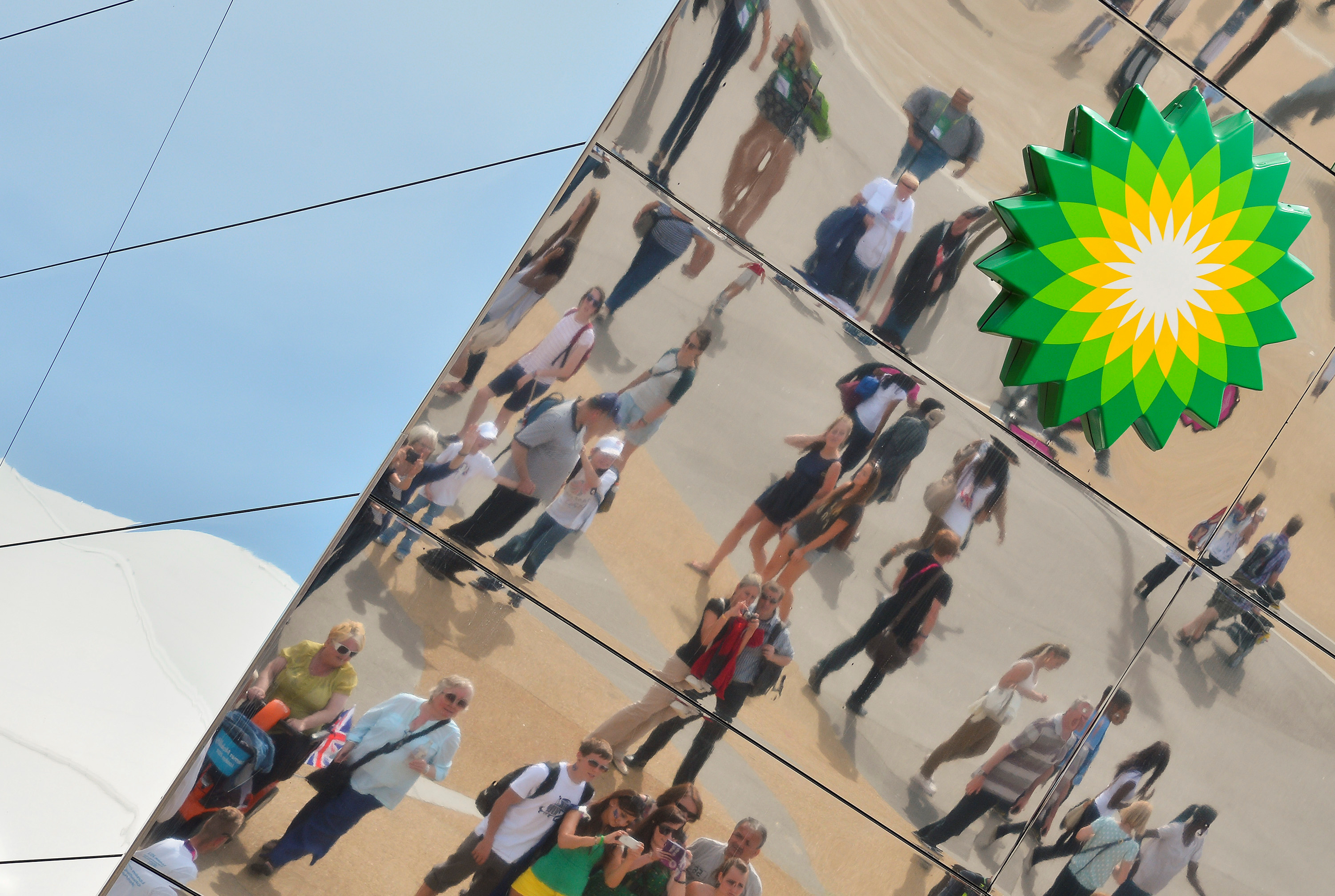 Spectators are seen reflected in a British Petroleum sponsors building in Olympic Park at the London 2012 Paralympic Games