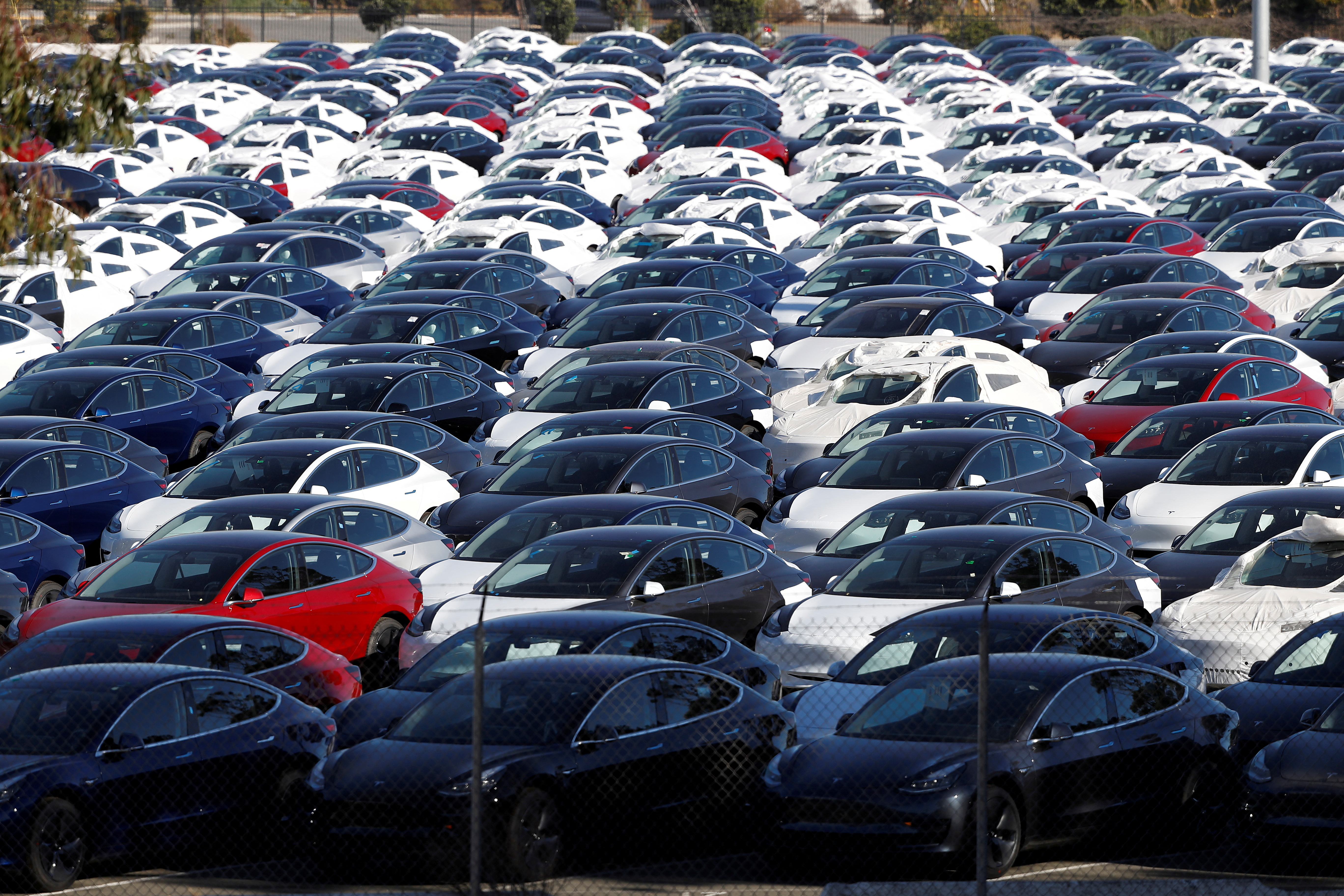 A parking lot of predominantly new Tesla Model 3 electric vehicles is seen in Richmond, California