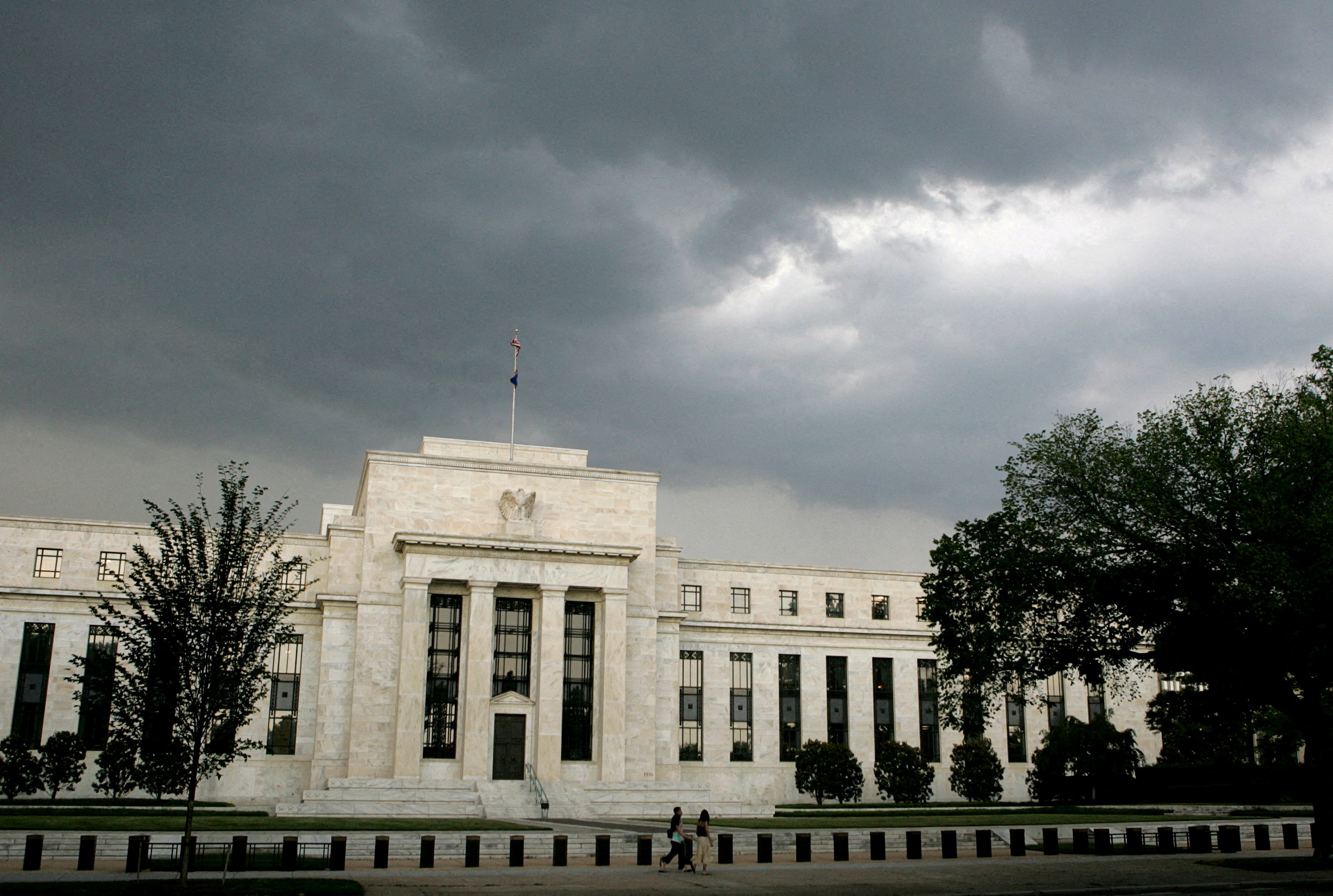 Storm clouds gather over U.S. Federal Reserve Building before evening thunderstorm in Washington