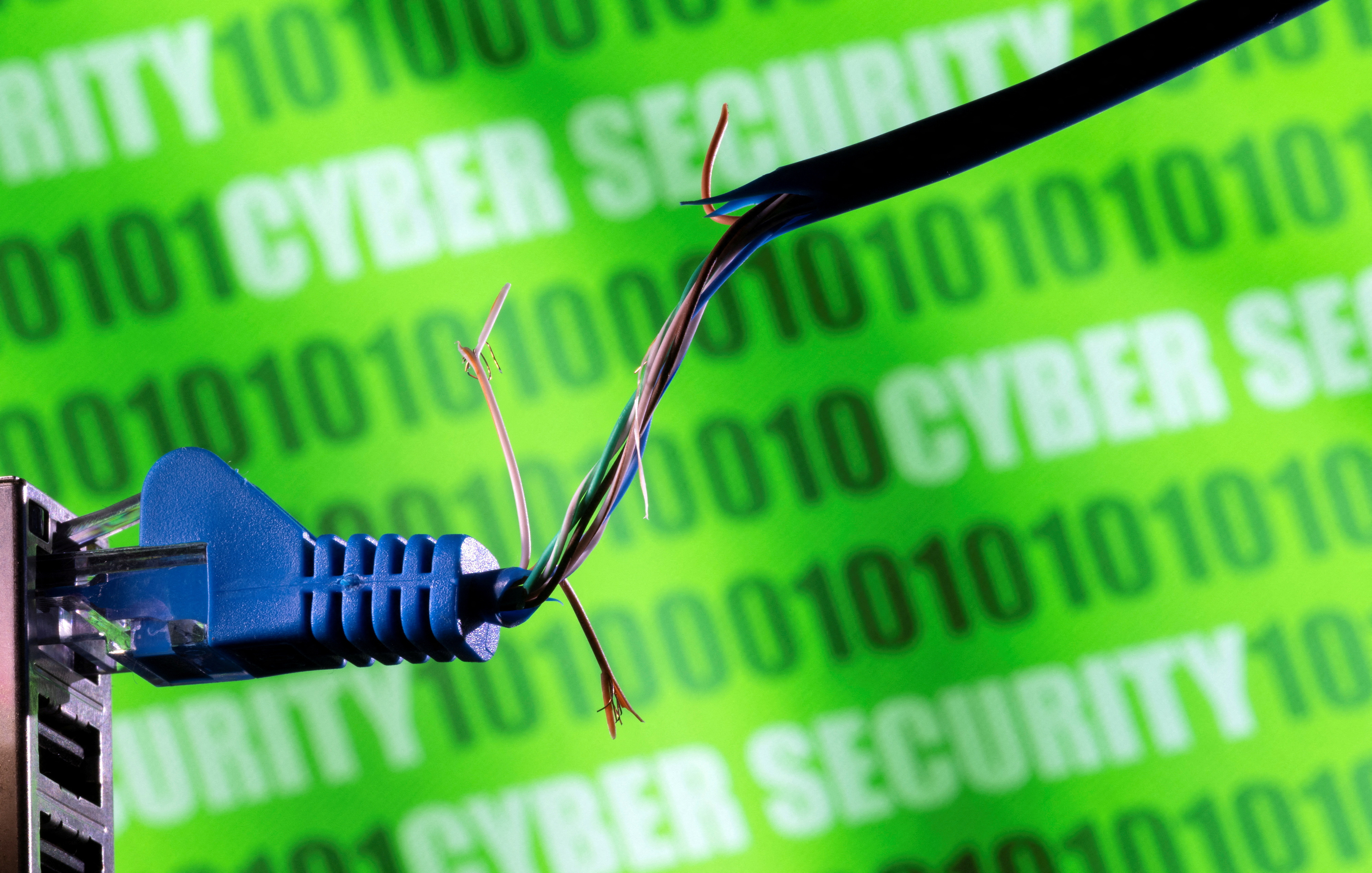 Illustration shows broken Ethernet cable, binary code and words "cyber security