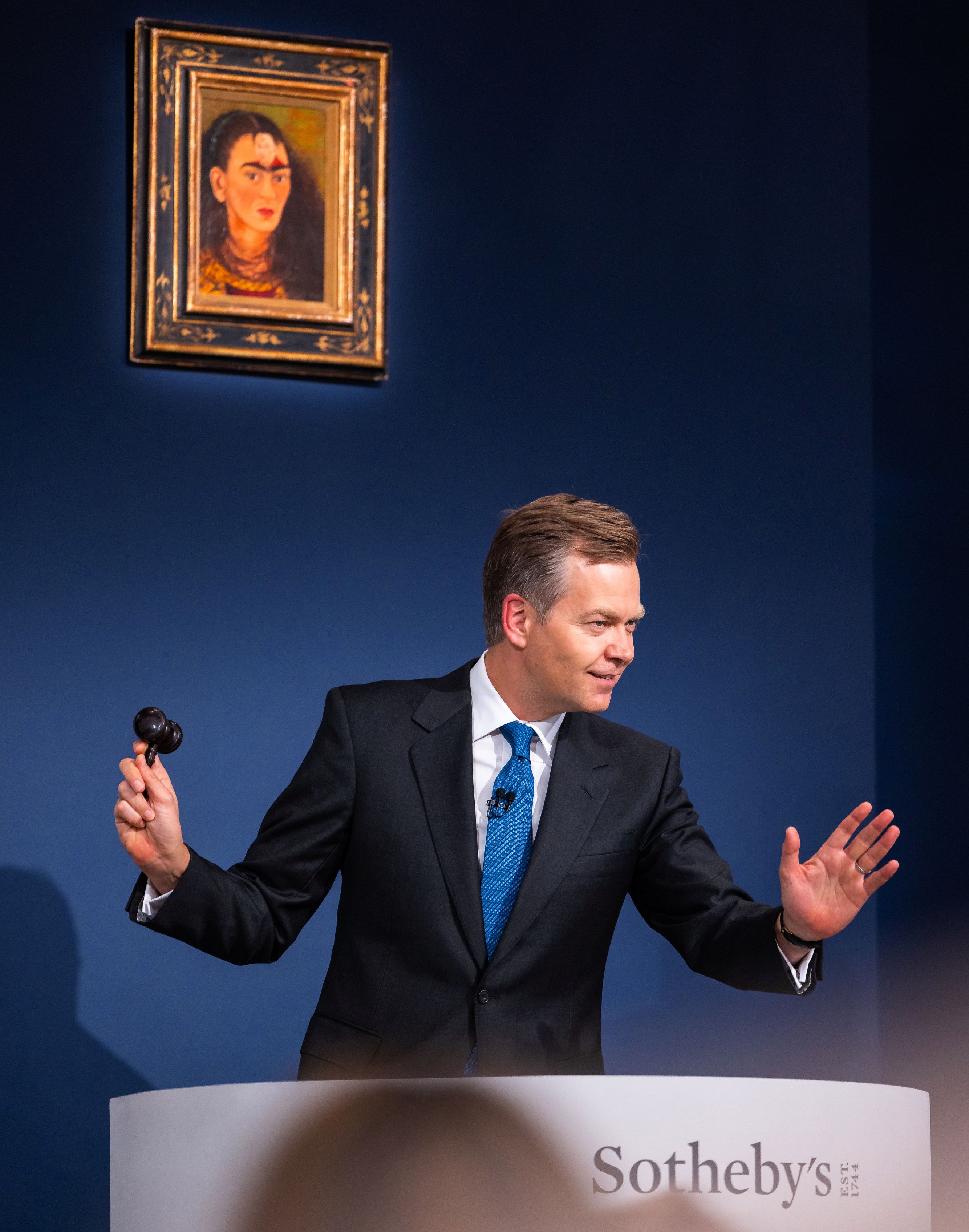 Auctioneer Oliver Barker, Chairman of Sotheby's Europe, sells a Frida Kahlo self portrait for $34.9 Million USD during an art auction, in the Manhattan borough of New York City, New York, U.S., November 16, 2021.  Julian Cassady/SOTHEBY'S/Handout via REUTERS