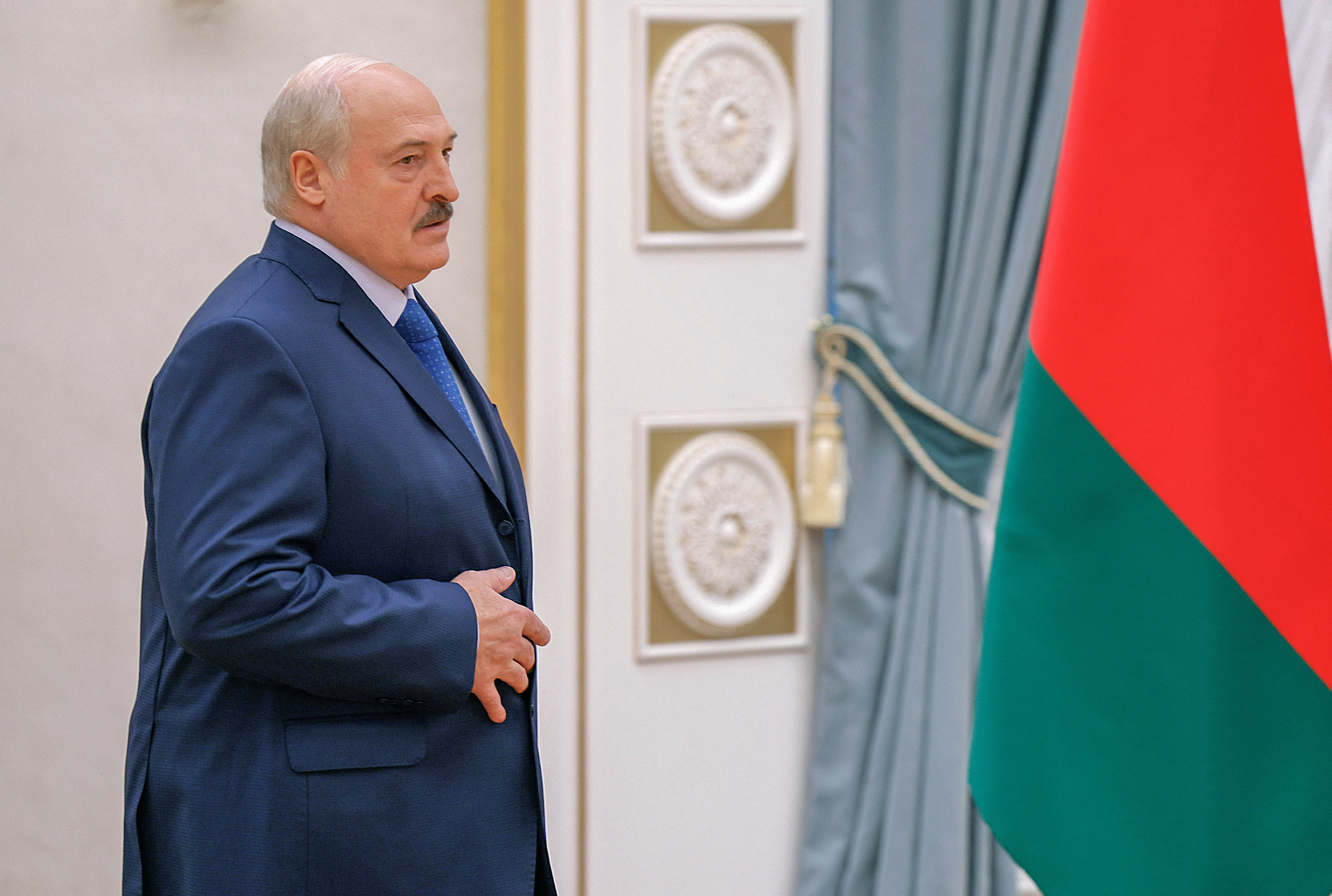 Belarusian President Alexander Lukashenko walks before a press conference in Minsk
