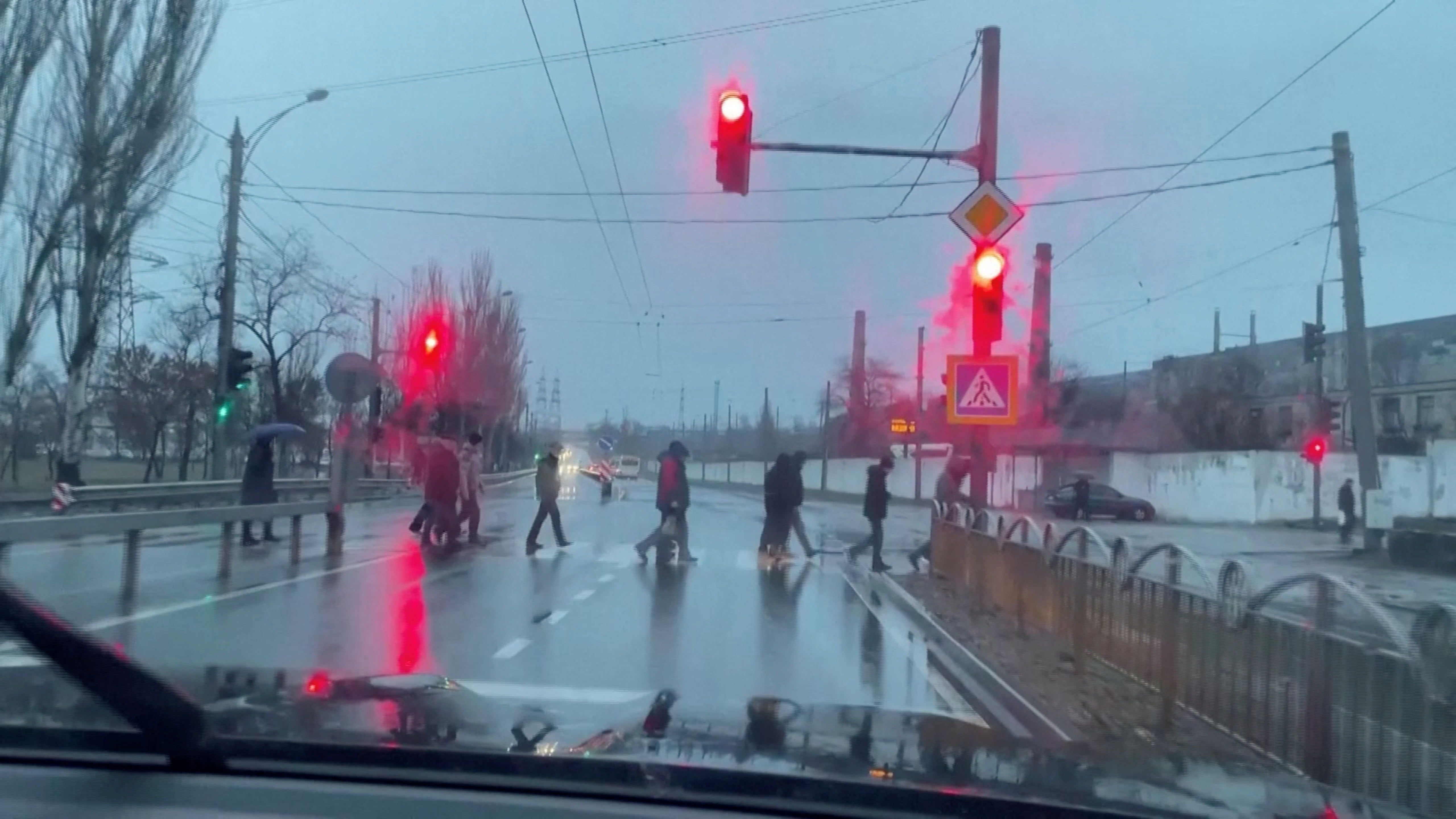 People cross street in the eastern town of Mariupol