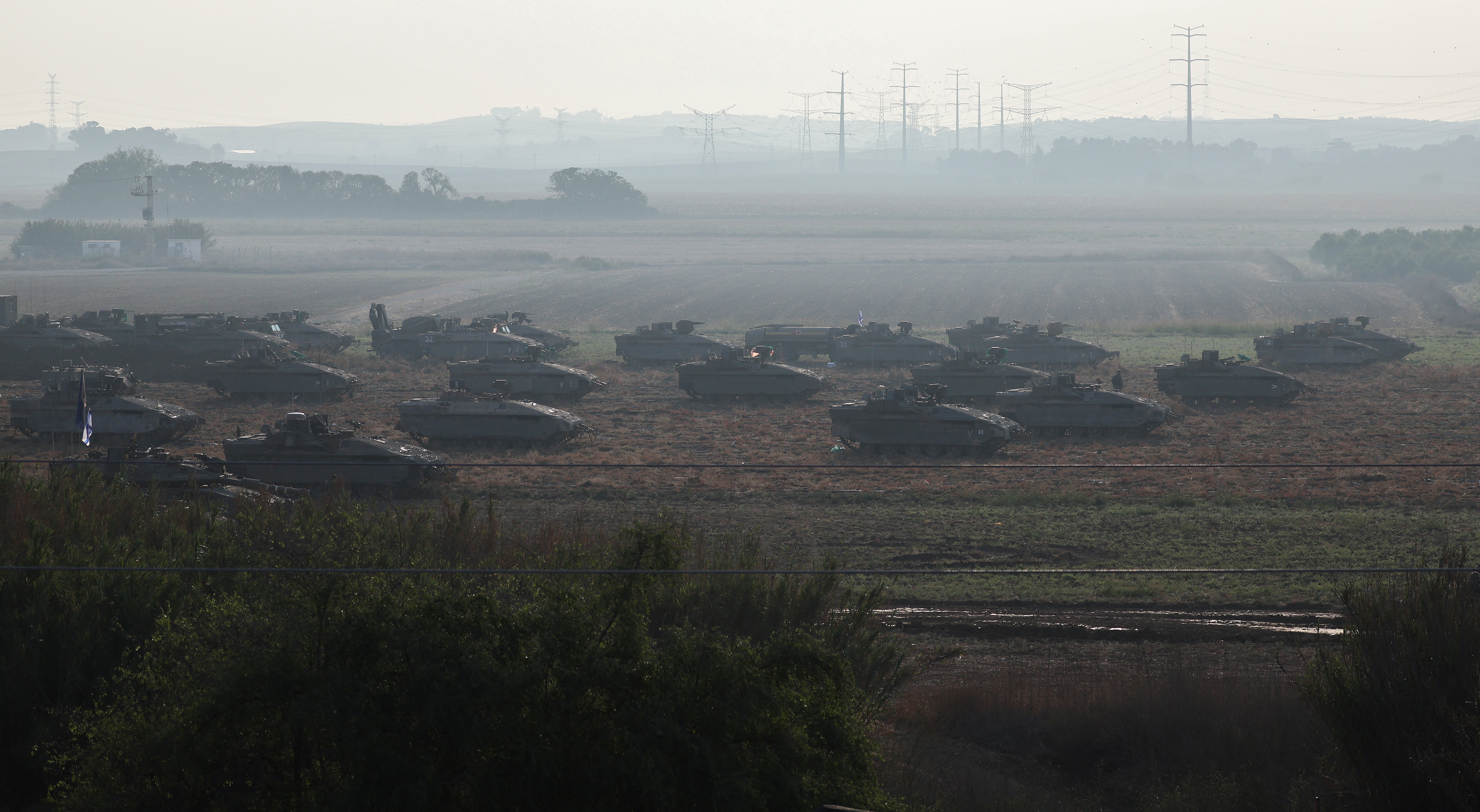 Israeli tanks and military vehicles take position near Israel's border with the Gaza Strip