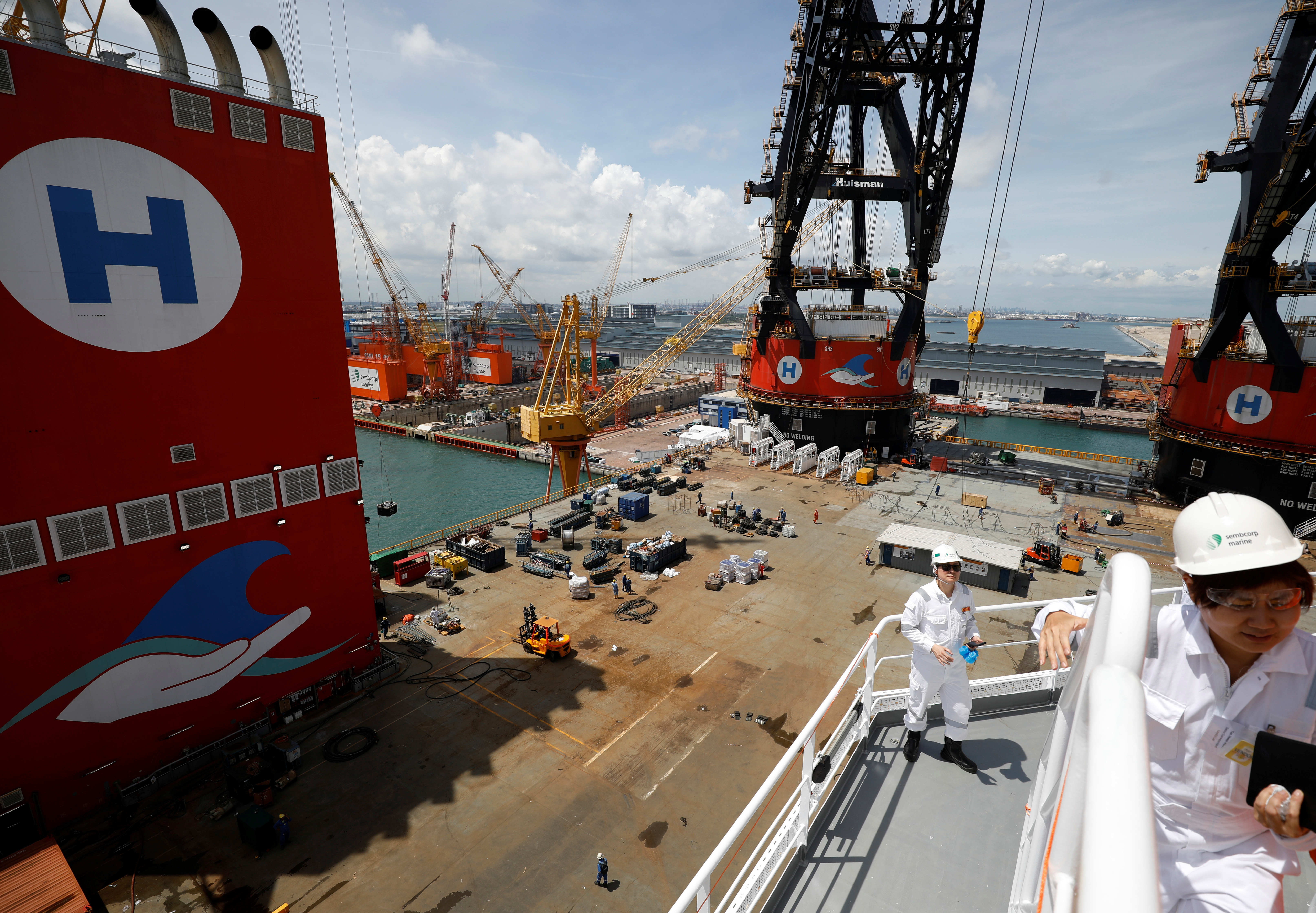 Members of the media tour operate deck of the Heerema Marine Contractors' Sleipnir, the world's largest semi-submersible crane vessel, at the Sembcorp Marine shipyard in Singapore