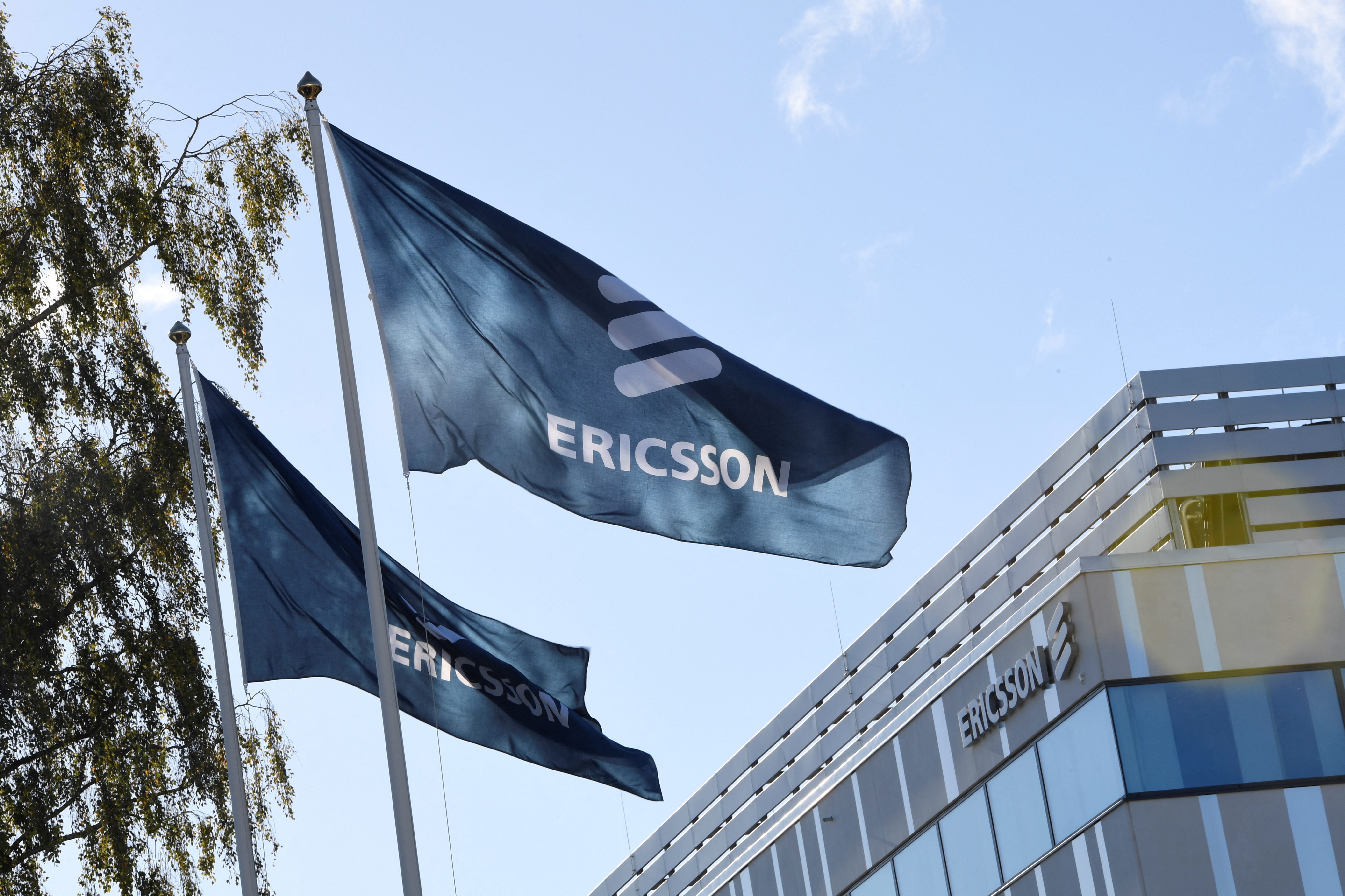 Flags with Ericsson logo are pictured outside company's head office in Stockholm