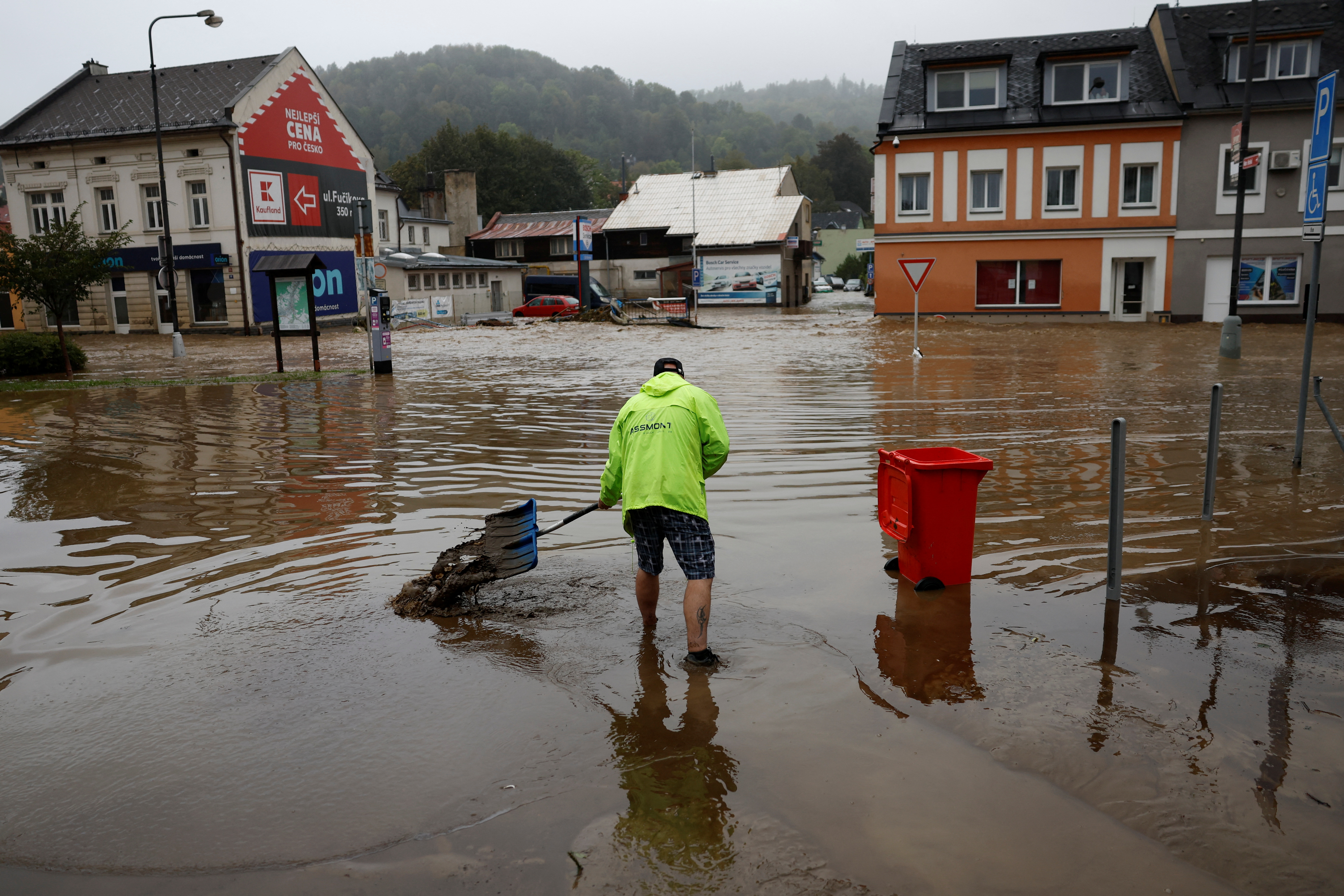 A man shovels as he stands in floodwater at a flooded area, following heavy rainfall in Jesenik, Czech Republic, September 15, 2024. REUTERS/David W Cerny