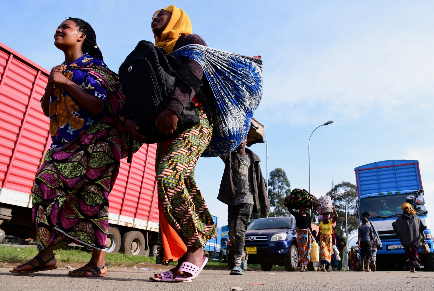 Congolese civilians carry their belongings at the Bunagana border crossing point