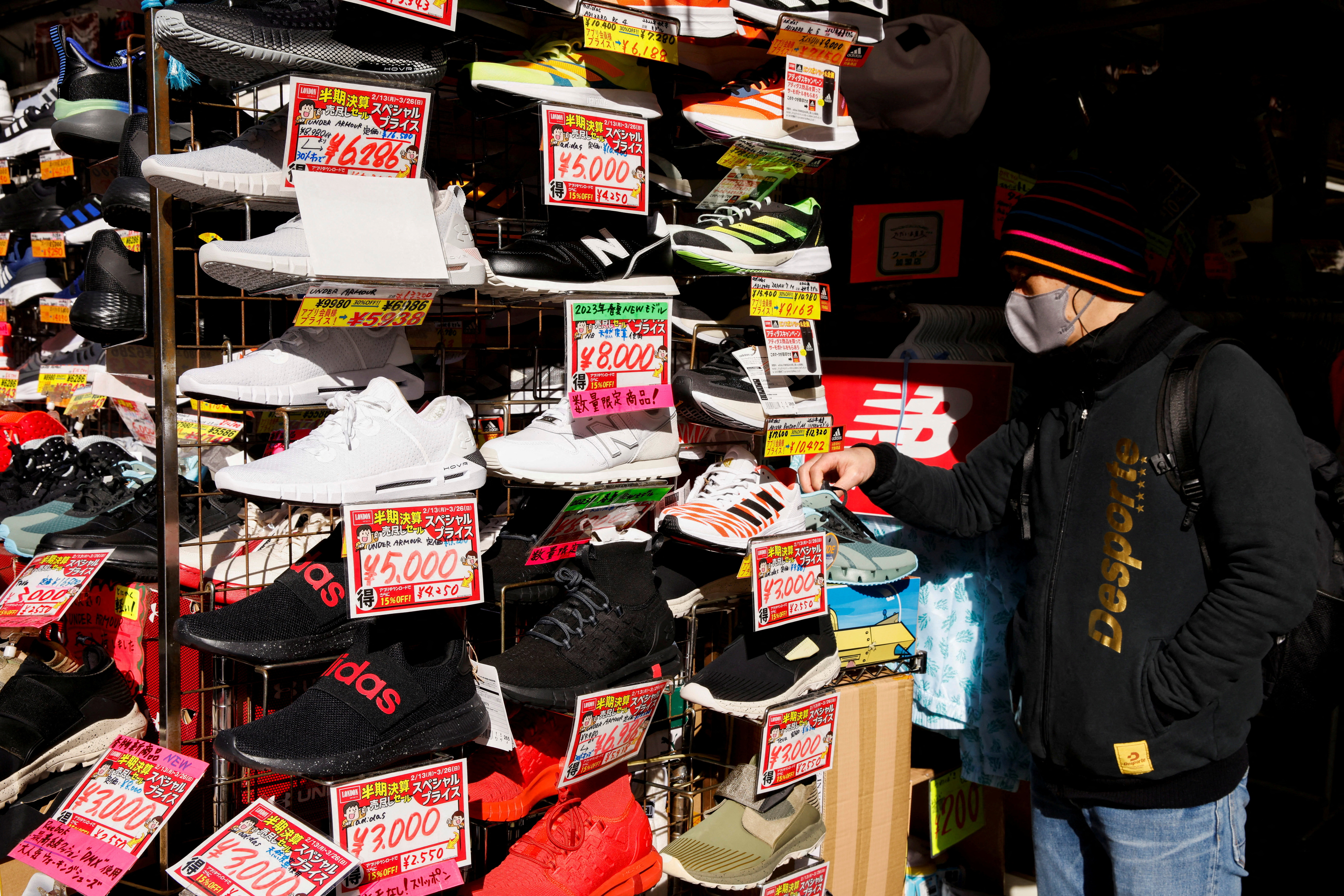 Man looks at sport shoes at a market in Tokyo