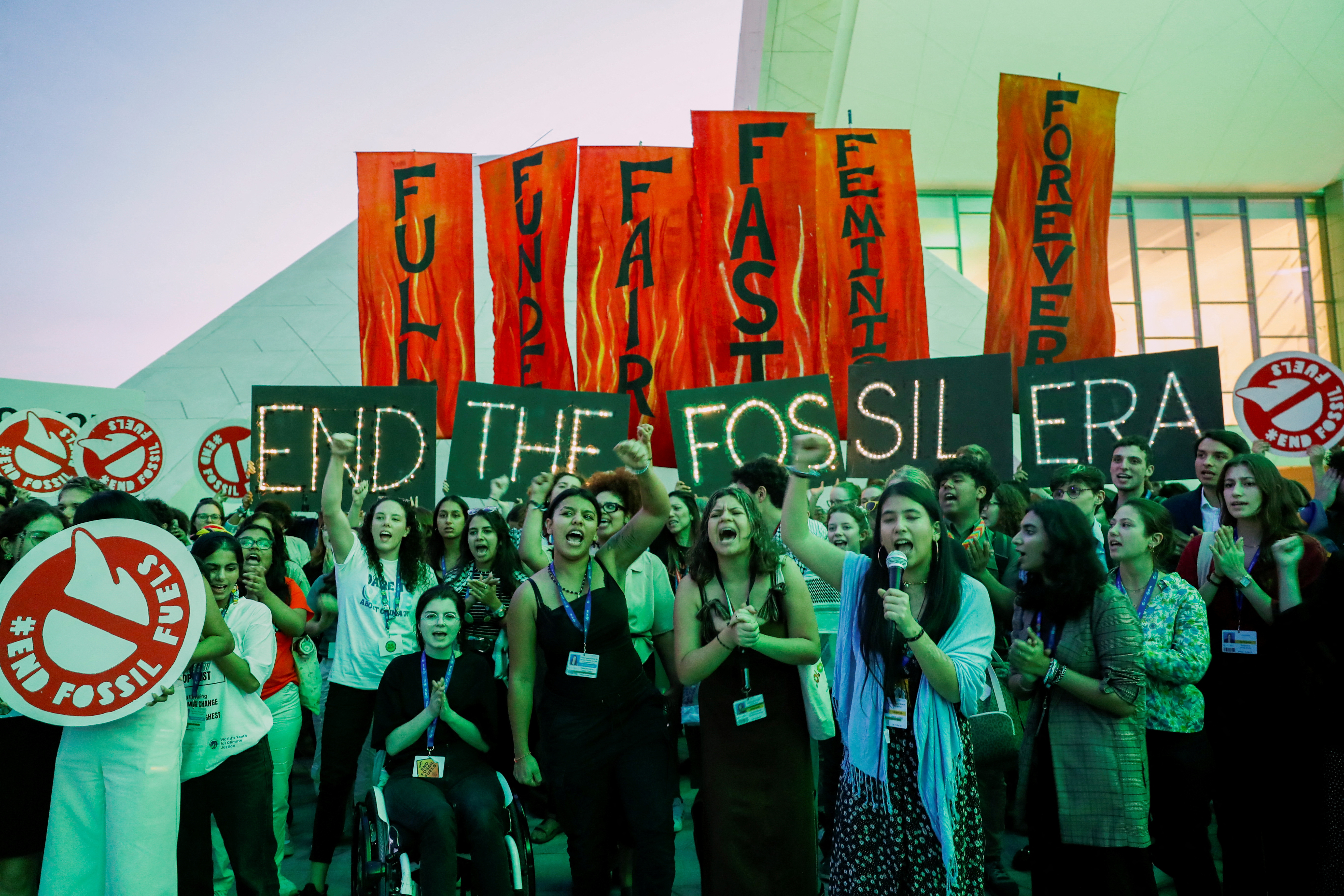 Climate activists protest against fossil fuels at Dubai's Expo City during COP28, in Dubai