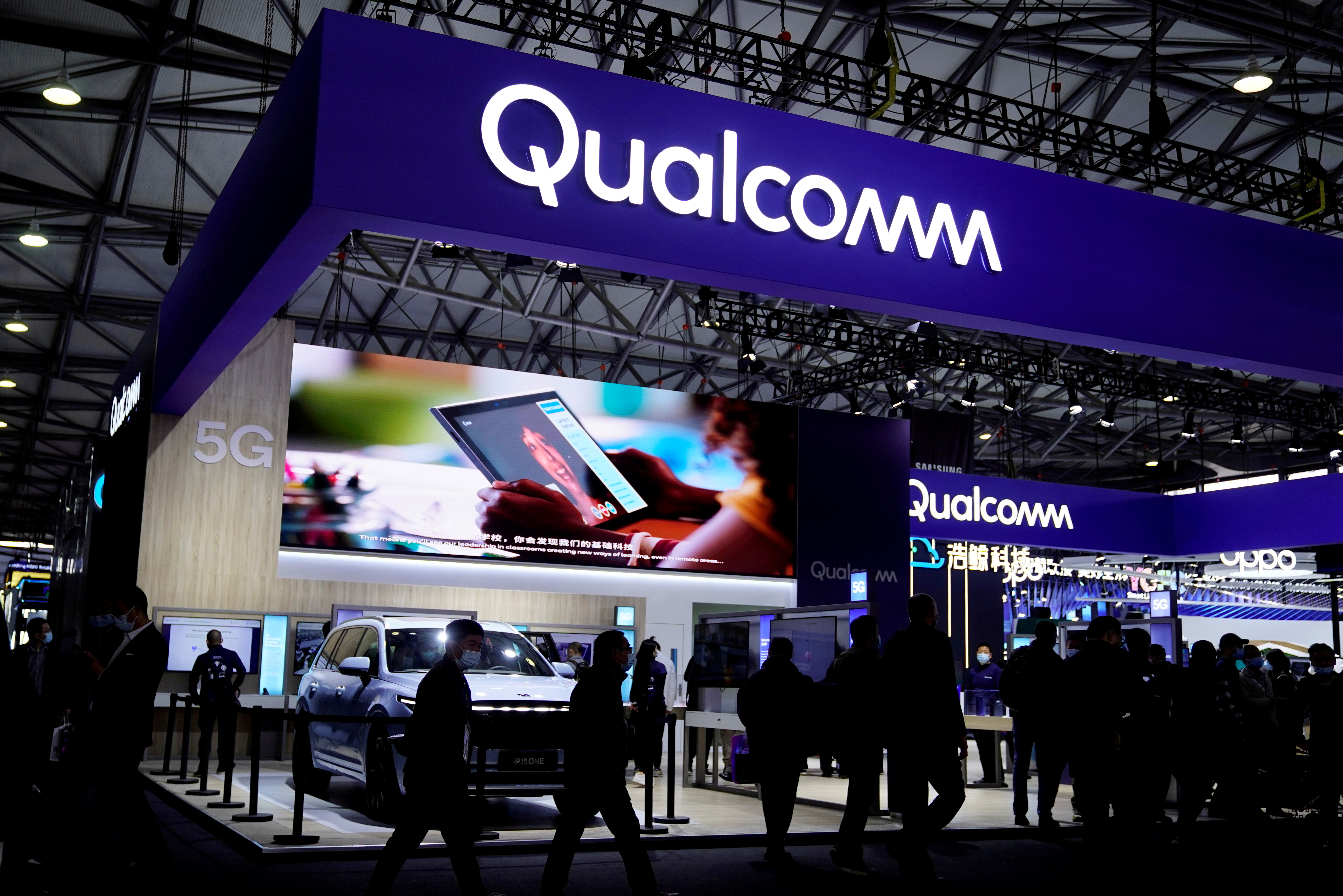 People visit a Qualcomm booth at the Mobile World Congress (MWC) in Shanghai, China February 23, 2021. REUTERS/Aly Song