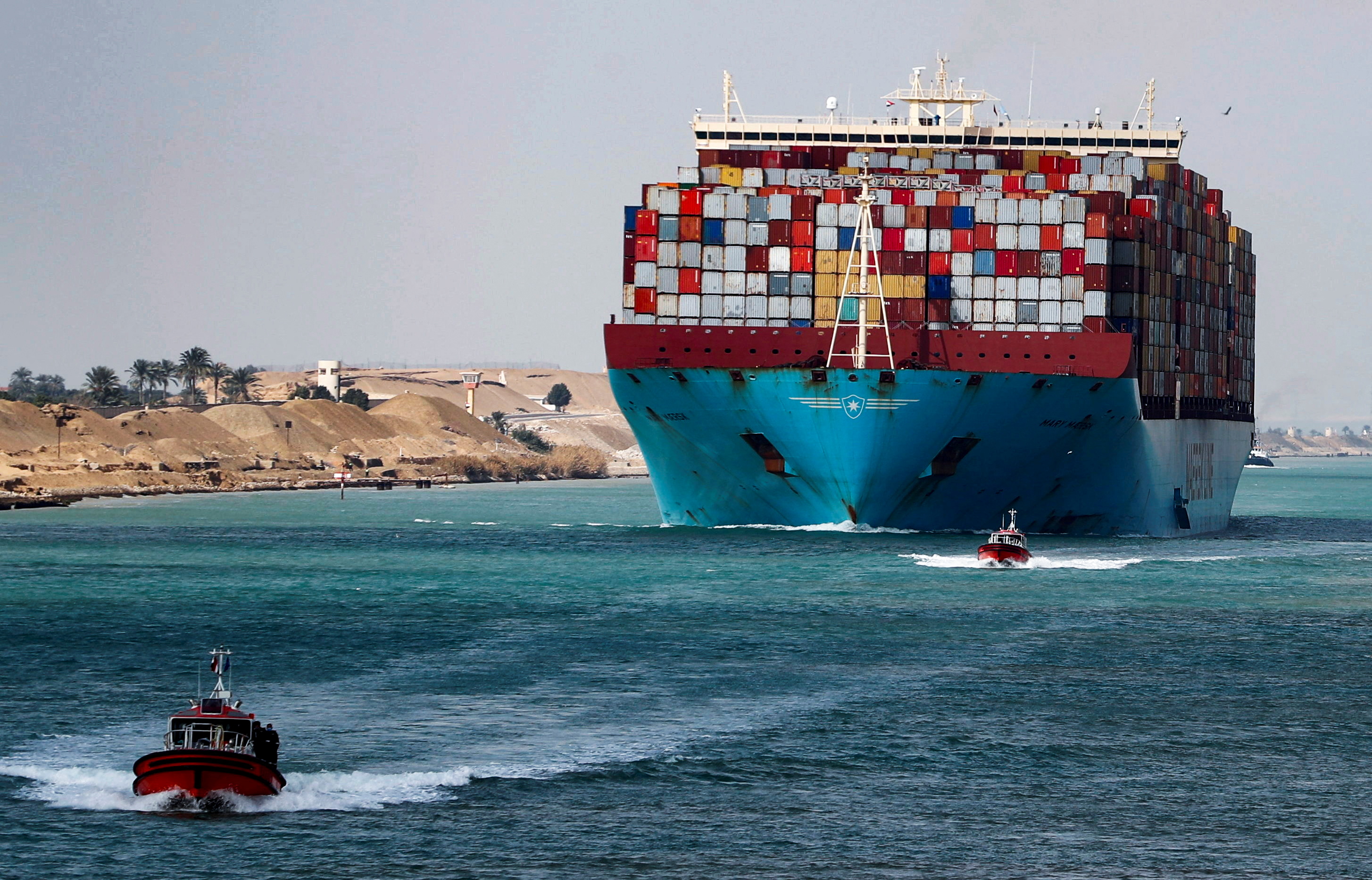 A shipping container passes through the Suez Canal in Suez