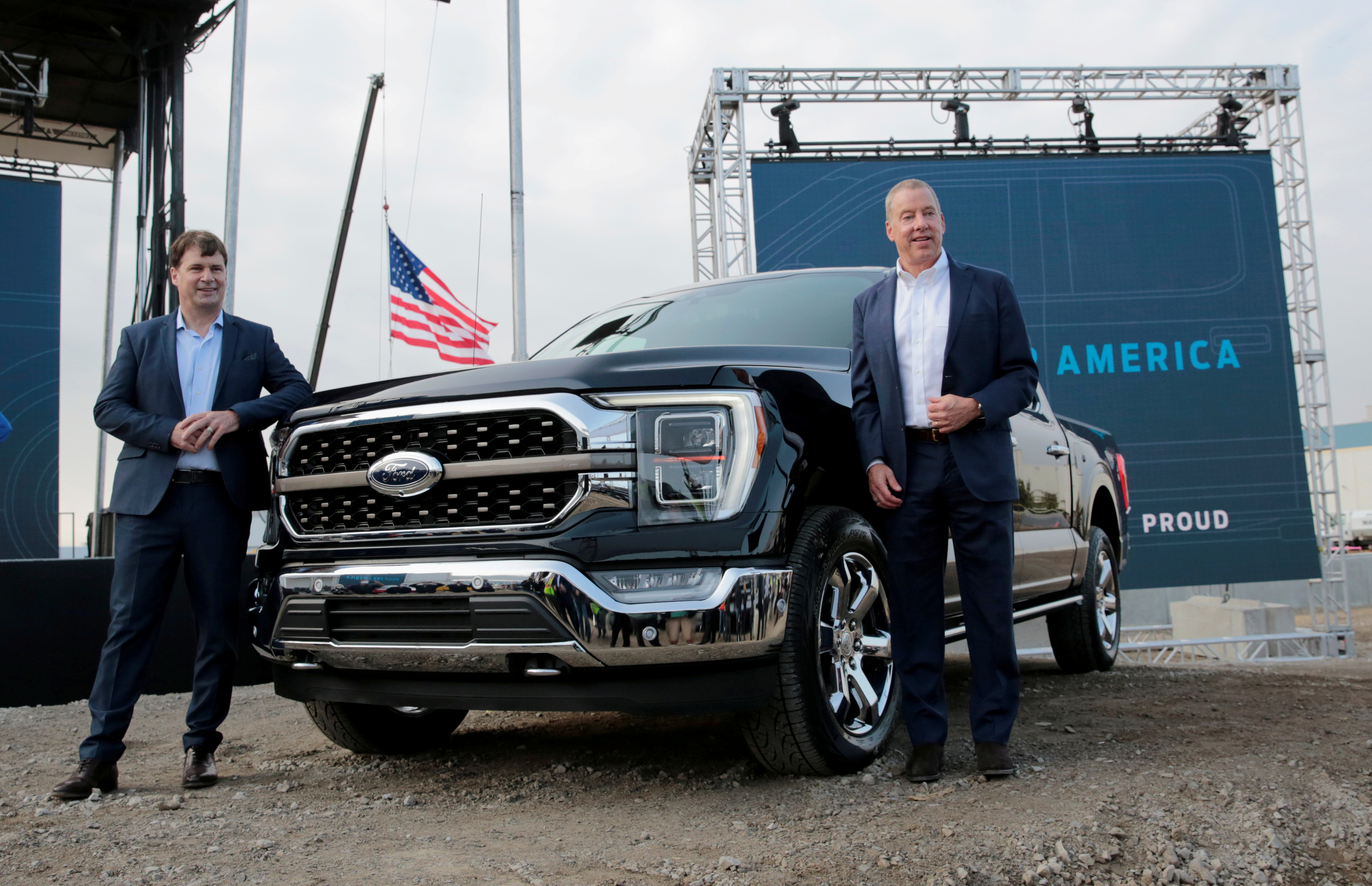 Ford Motor Co. CEO Jim Farley and Executive Chairman Bill Ford Jr. pose next to a new 2021 Ford F-150 pickup truck in Dearborn, Michigan