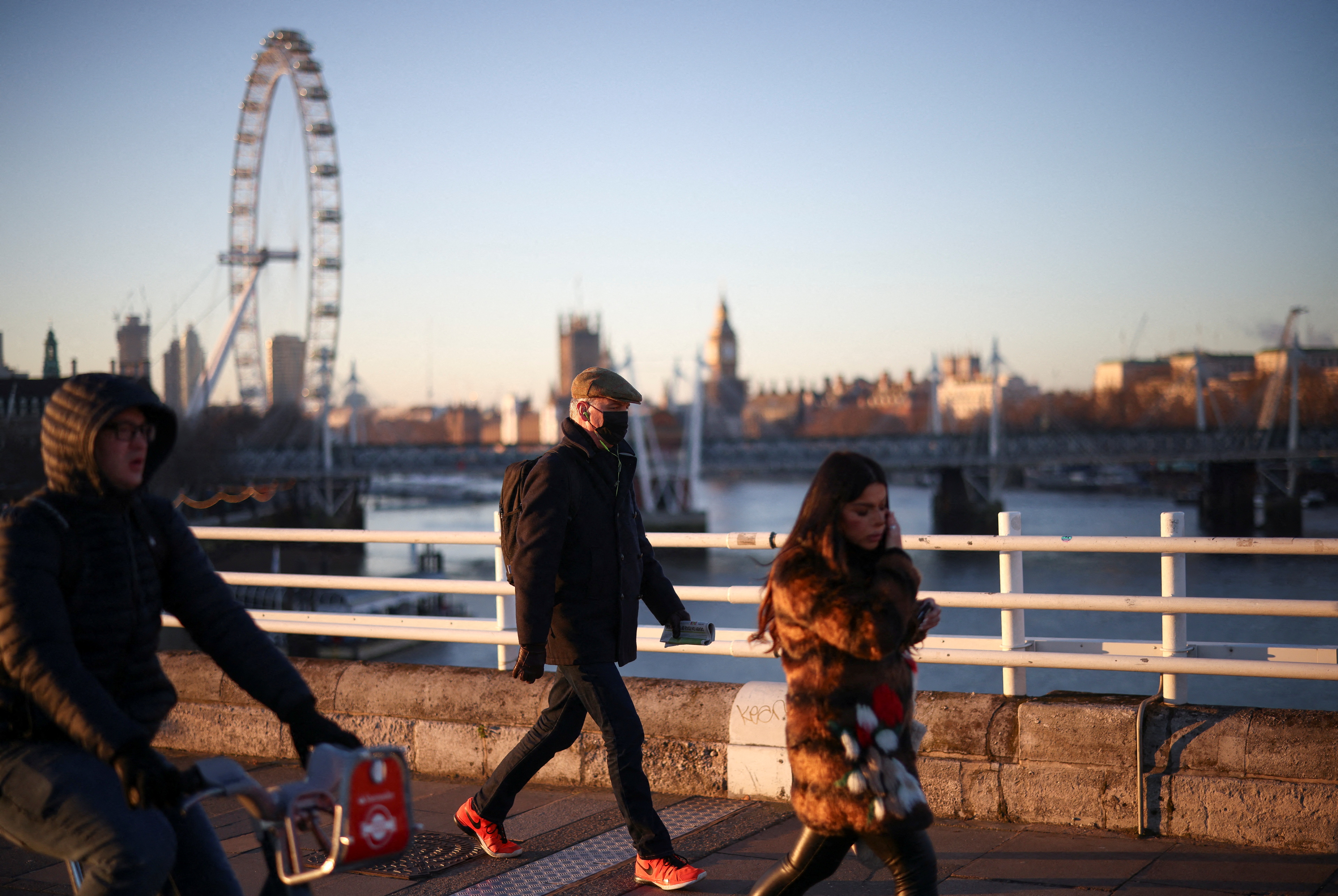 People walk and cycle over Waterloo Bridge during morning rush hour, amid the ongoing coronavirus disease (COVID-19) pandemic in London