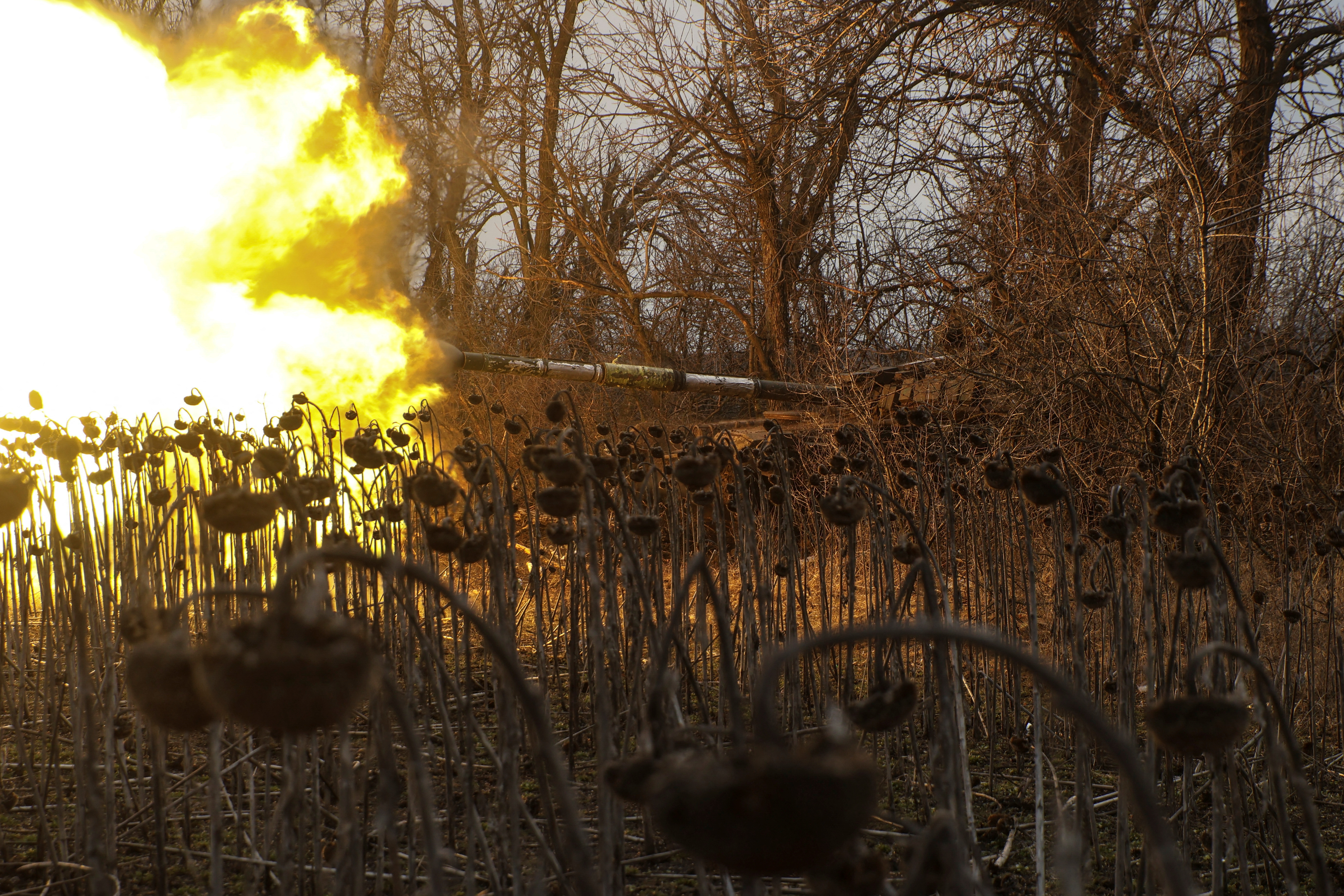 Ukrainian servicemen fire from a tank towards Russian troops near the frontline town of Bakhmut