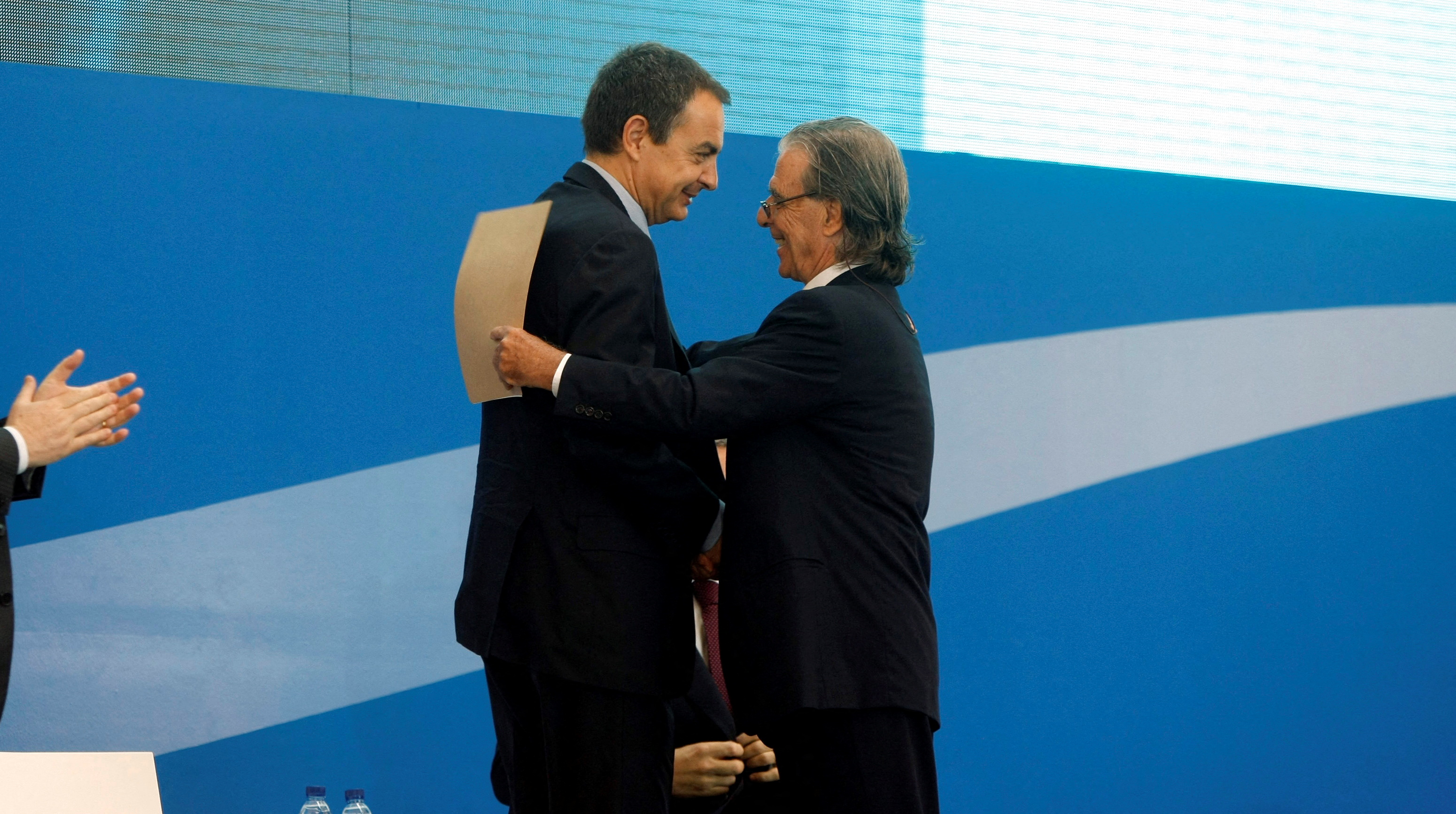 Spain's Prime Minister Zapatero embraces architect Ricardo Bofill during the inauguration of the T-1 terminal at Barcelona's El Prat airport