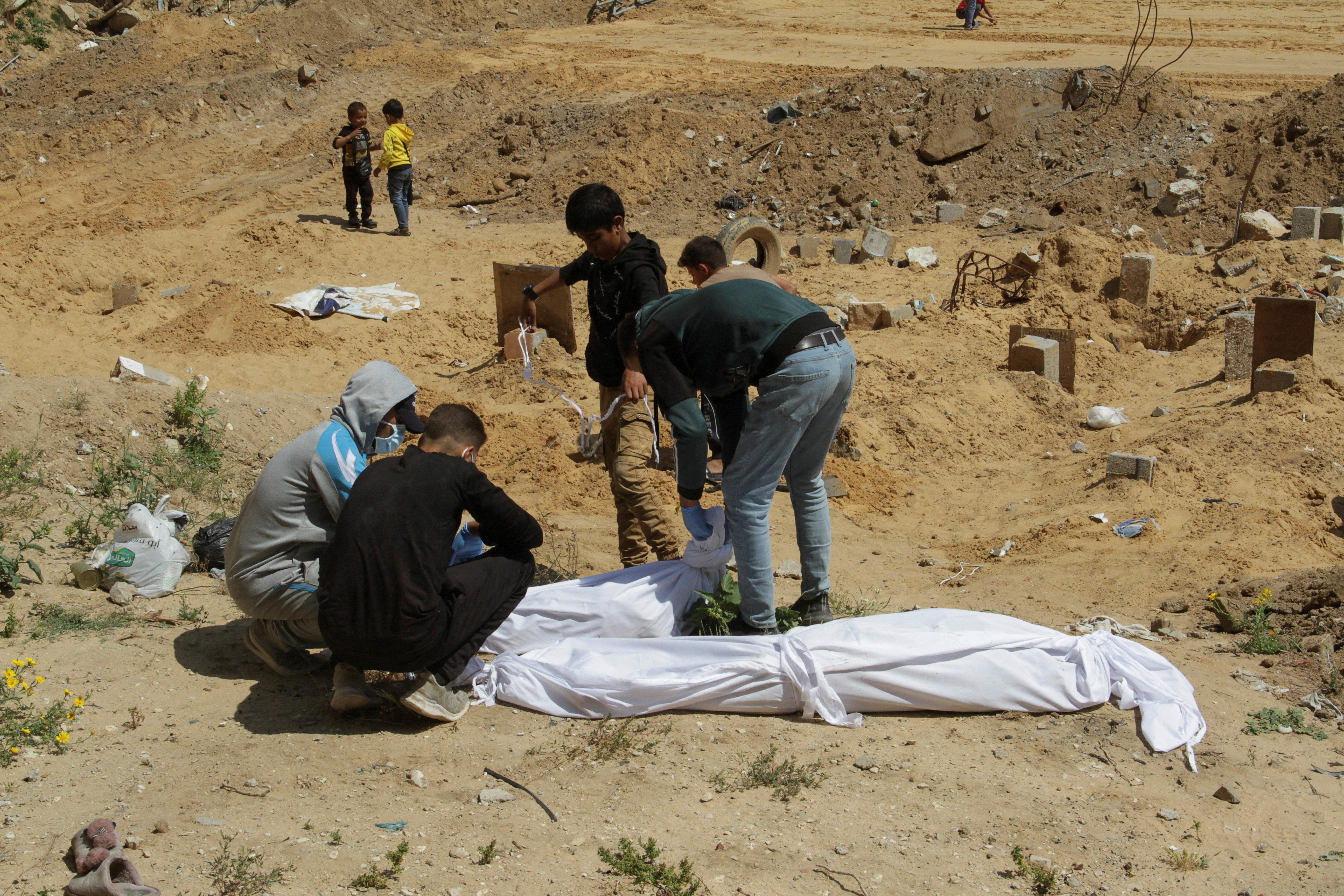 Palestinians find bodies buried in a mass grave, amid the ongoing conflict between Israel and Hamas, in northern Gaza Strip