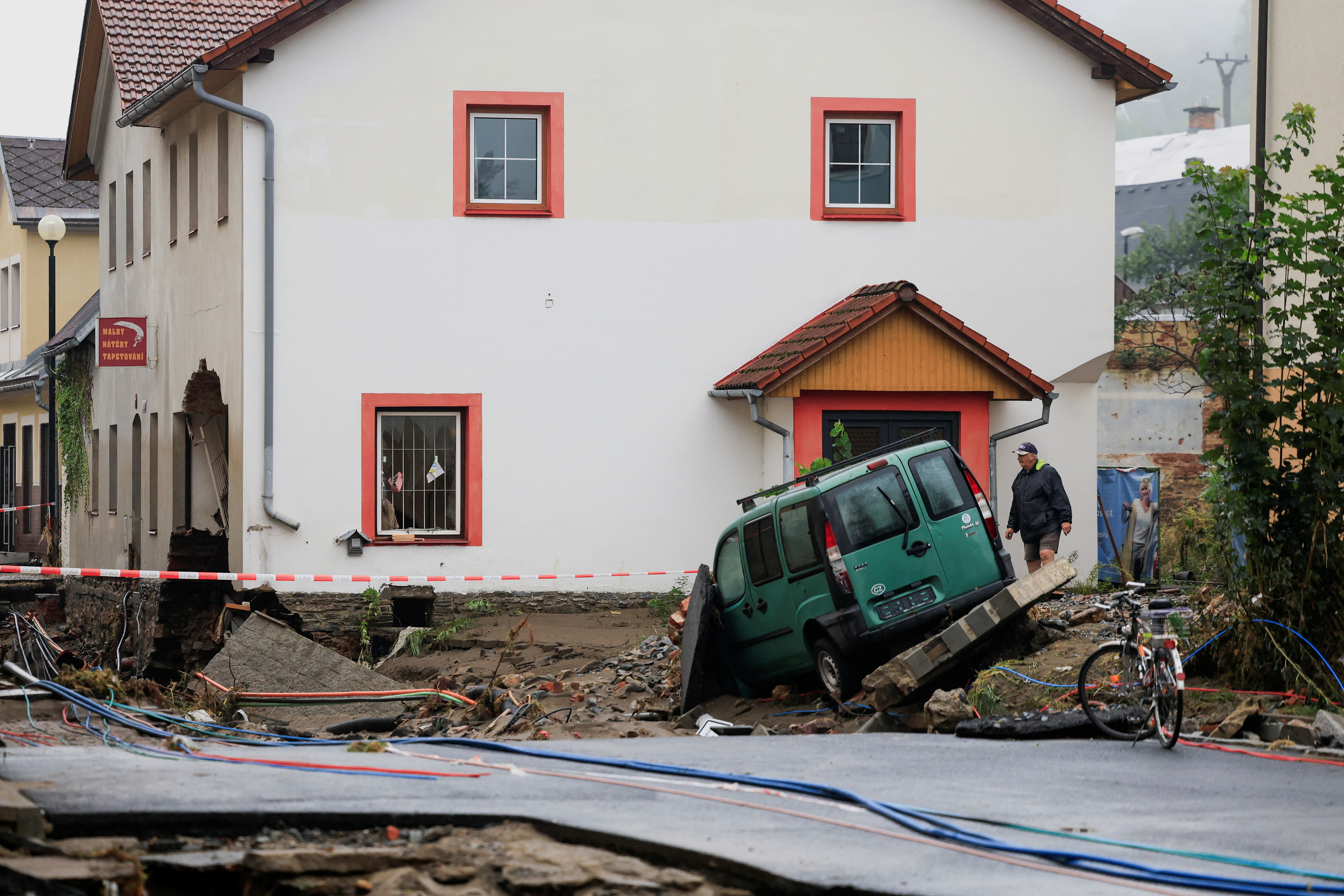 A man walks next to a damaged building, in the aftermath of flooding following heavy rainfalls, in Jesenik, Czech Republic, September 16. REUTERS/David W Cerny