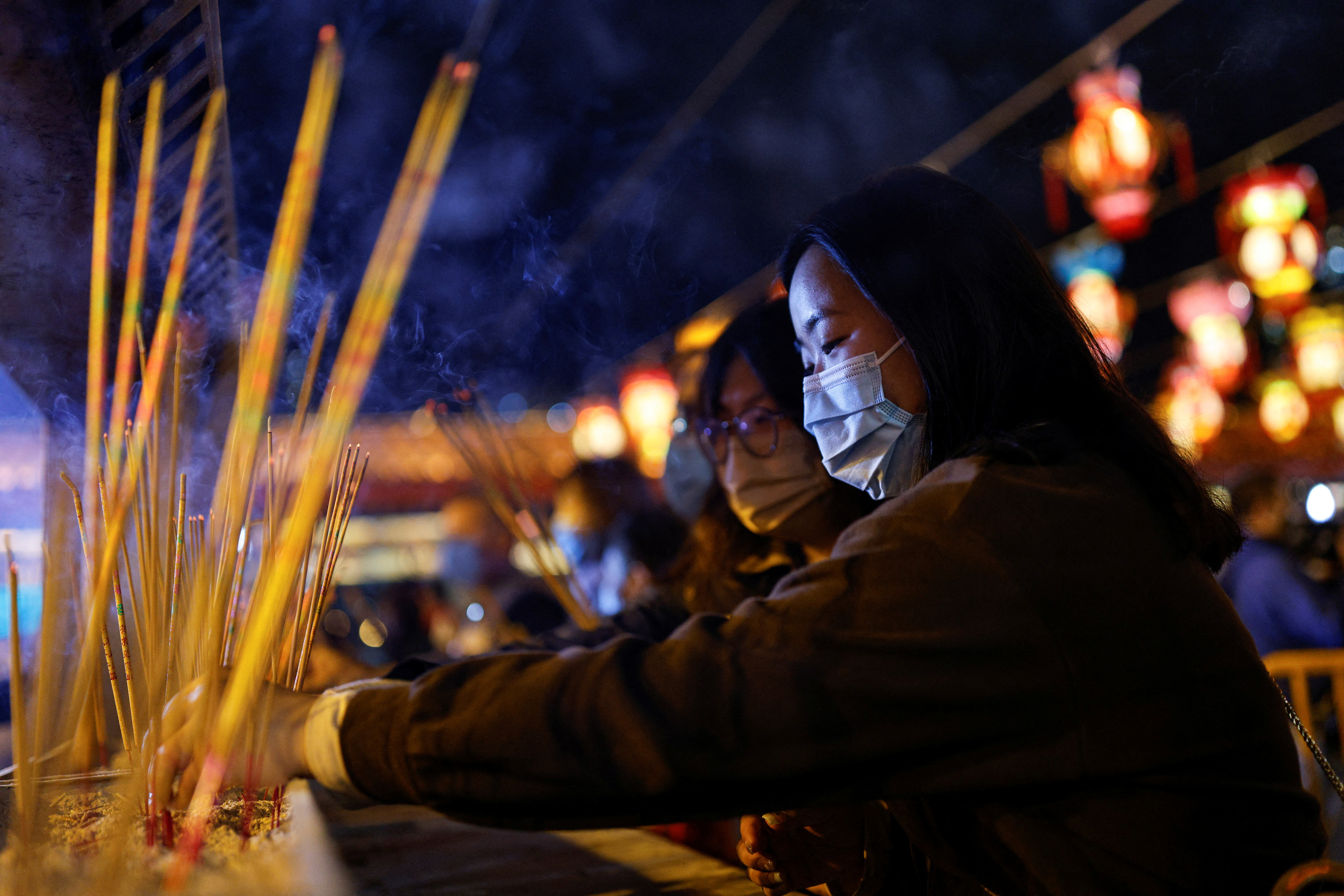 Chinese pray for health in Lunar New Year as Covid death toll rises