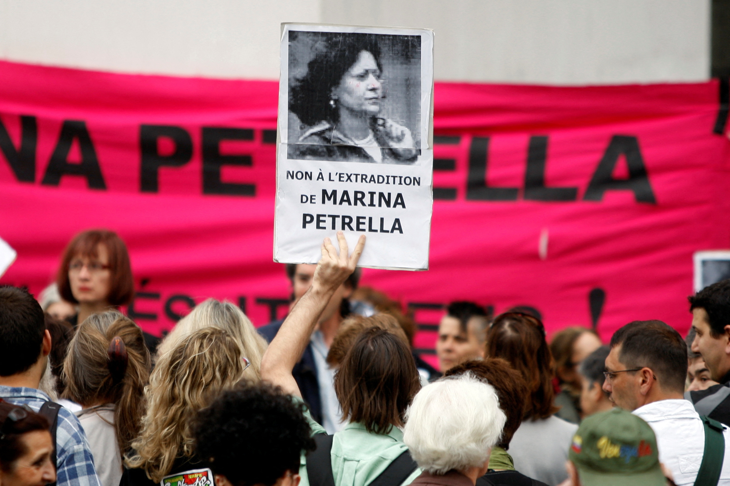 A demonstrator holds up a portrait of former member of the Red Brigades Marina Petrella during a protest in Paris