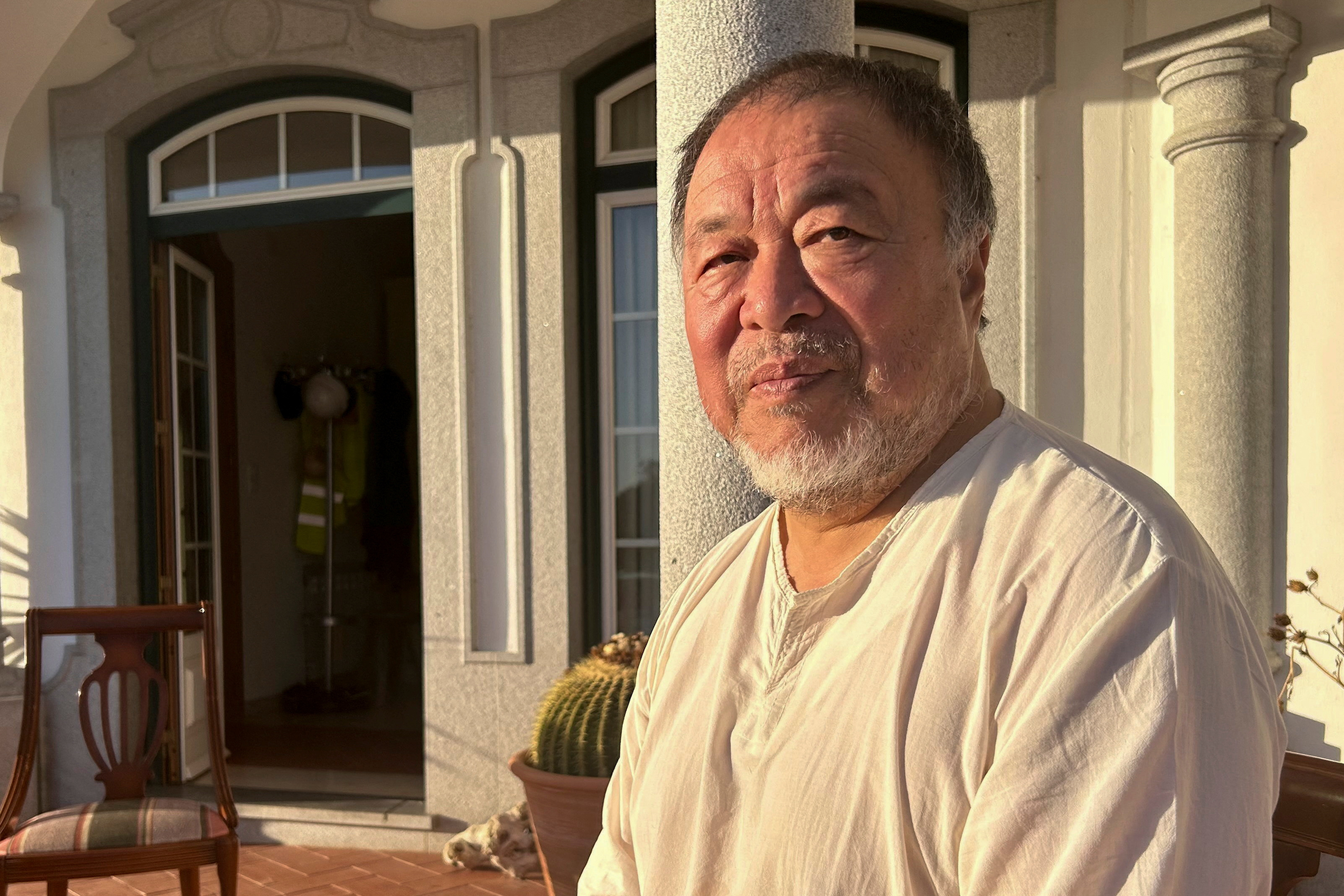 Chinese dissident artist Ai Weiwei poses for a photo after an interview with Reuters at Montemor-O-Novo