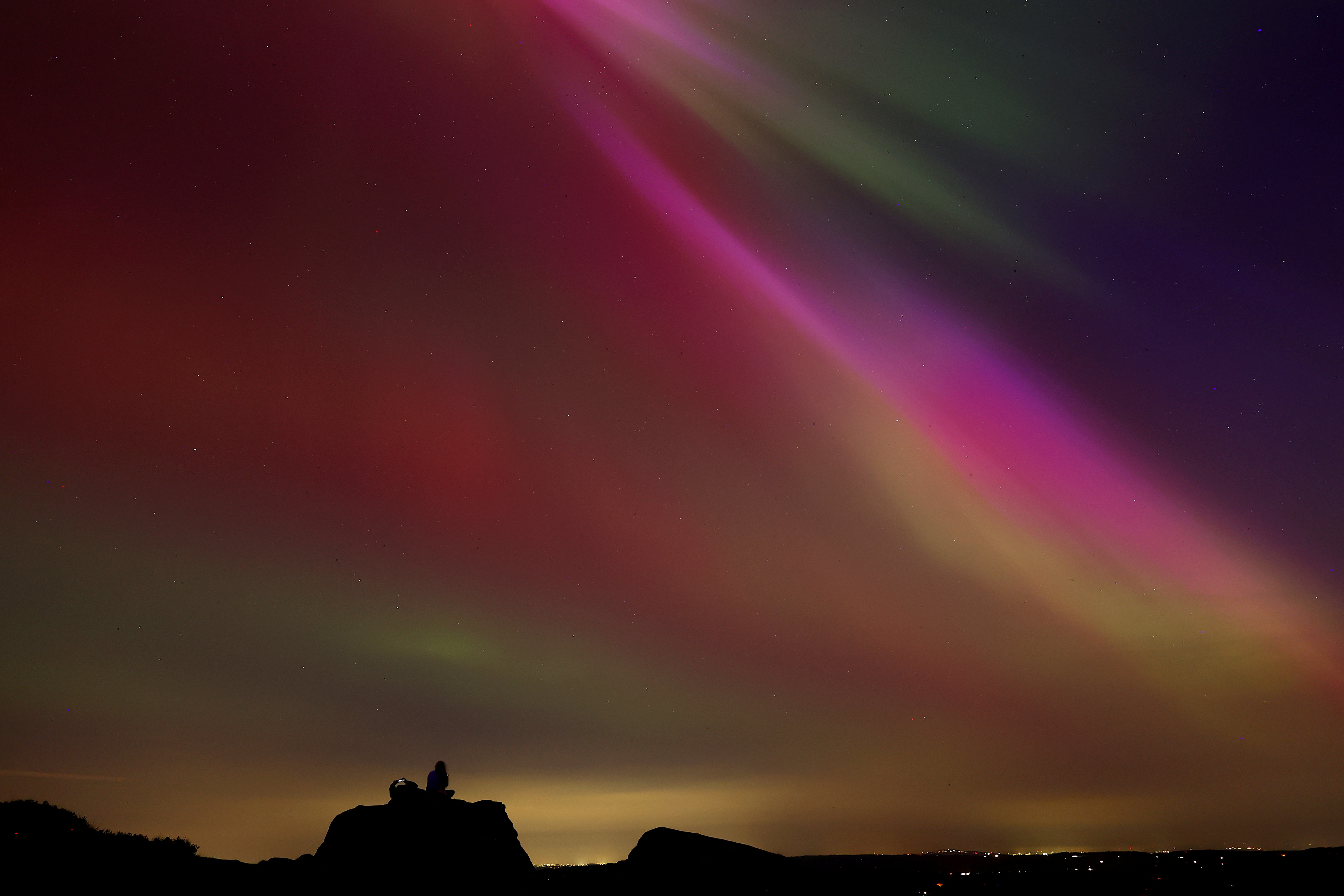 The aurora borealis, also known as the 'northern lights’, are seen over The Roaches near Leek