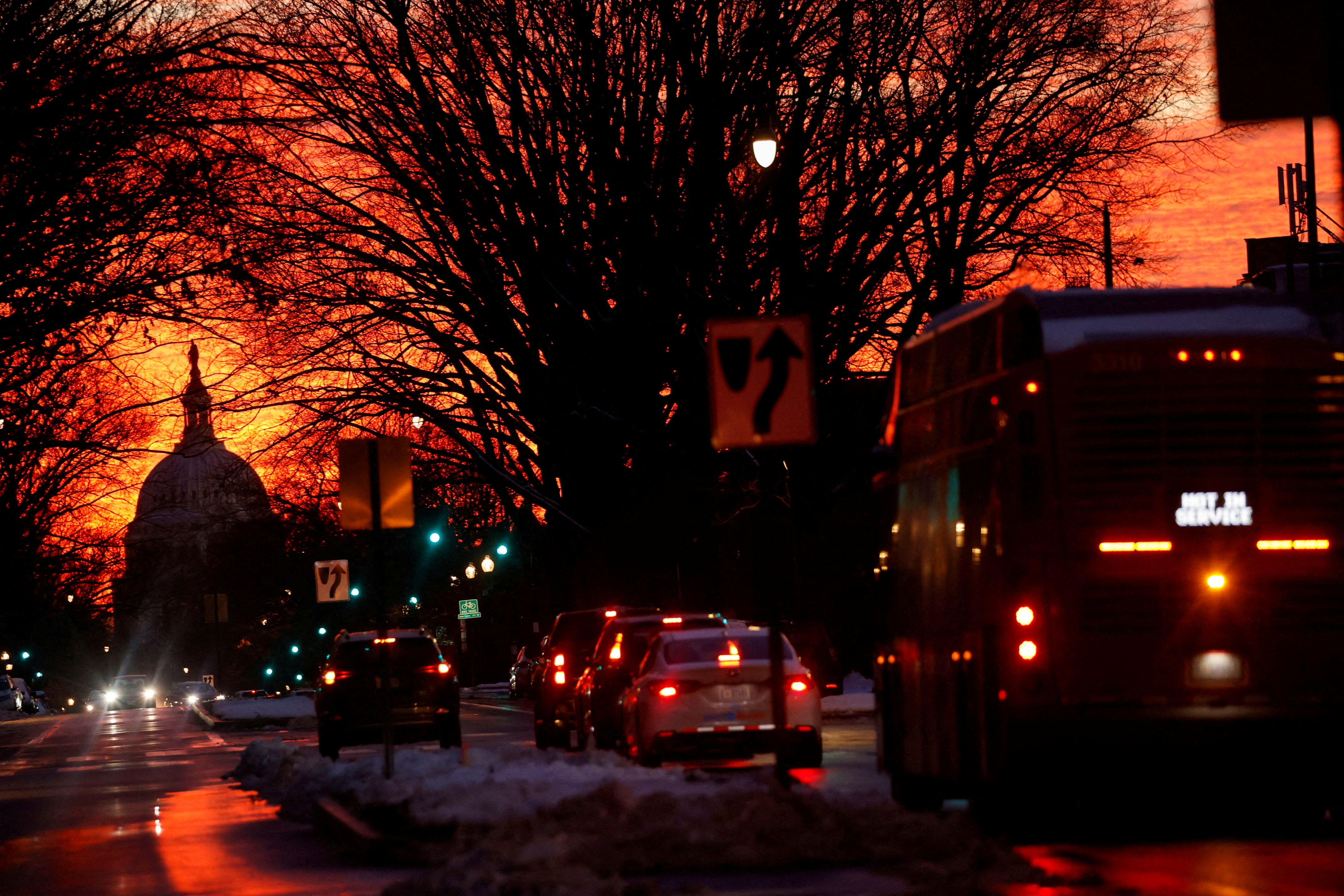 The sunset lights up the sky behind the U.S. Capitol dome in Washington