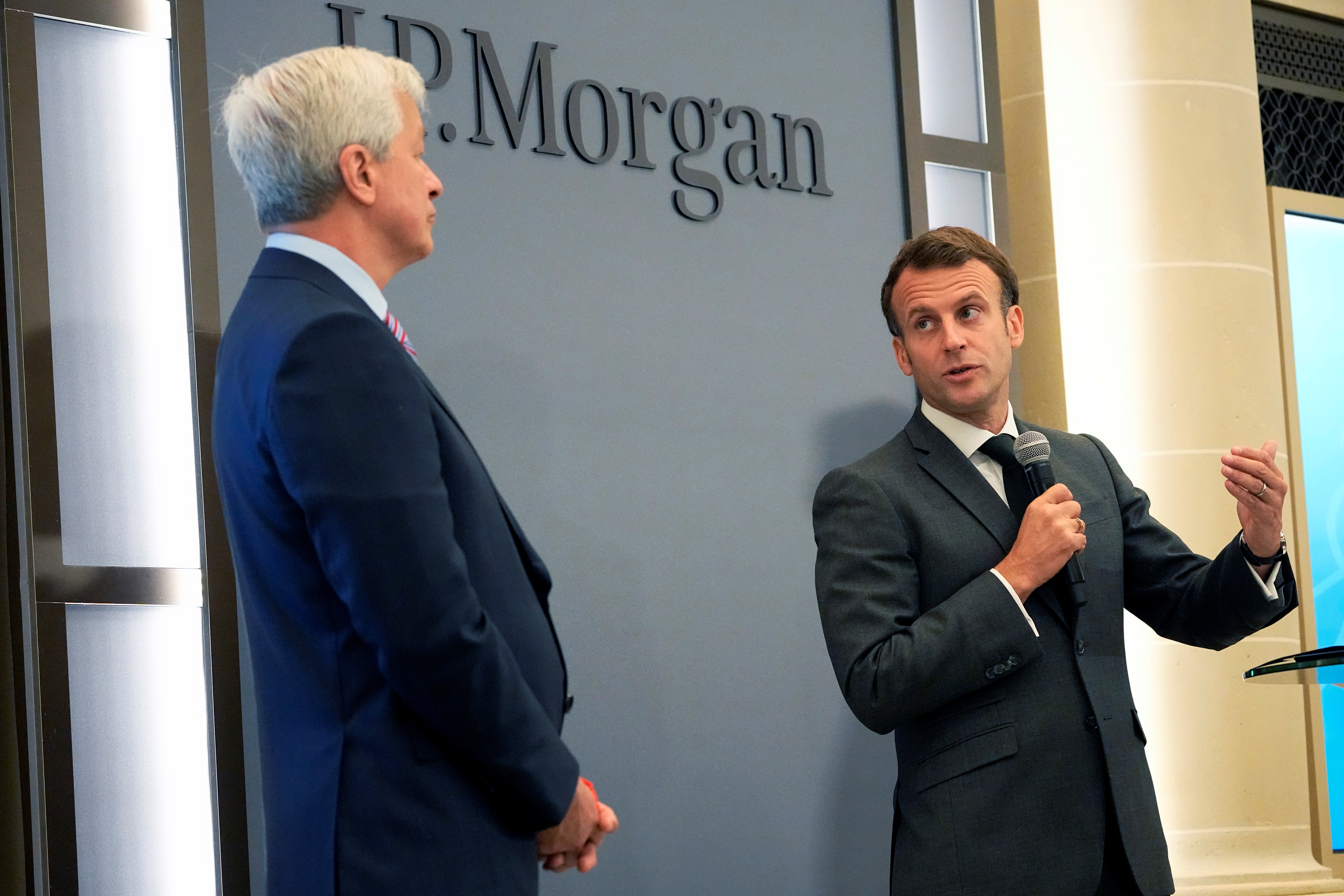 JP Morgan CEO Jamie Dimon listens to French President Emmanuel Macron as they inaugurate the new French headquarters of JP Morgan bank in Paris