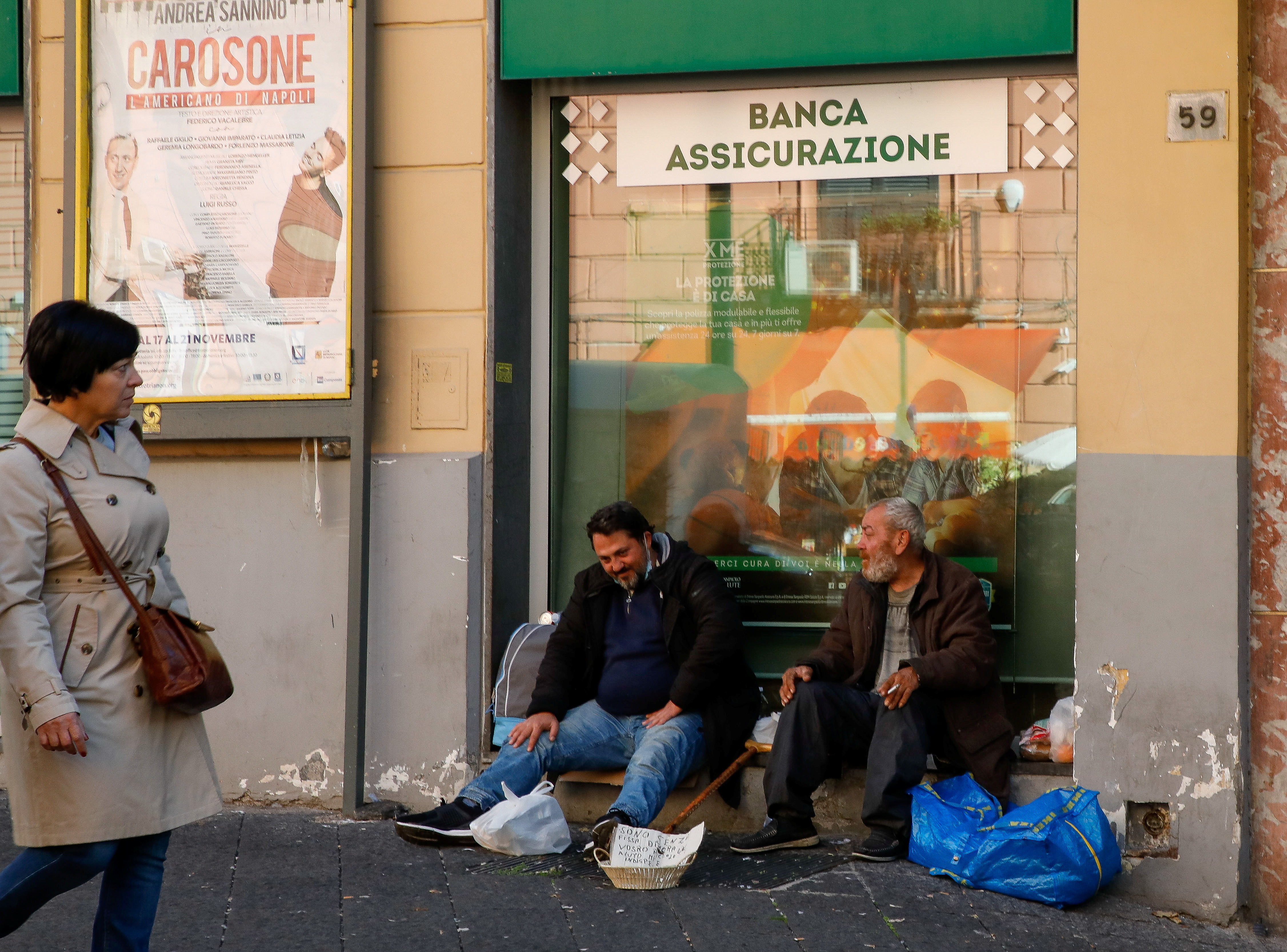 Men beg on the street in Naples