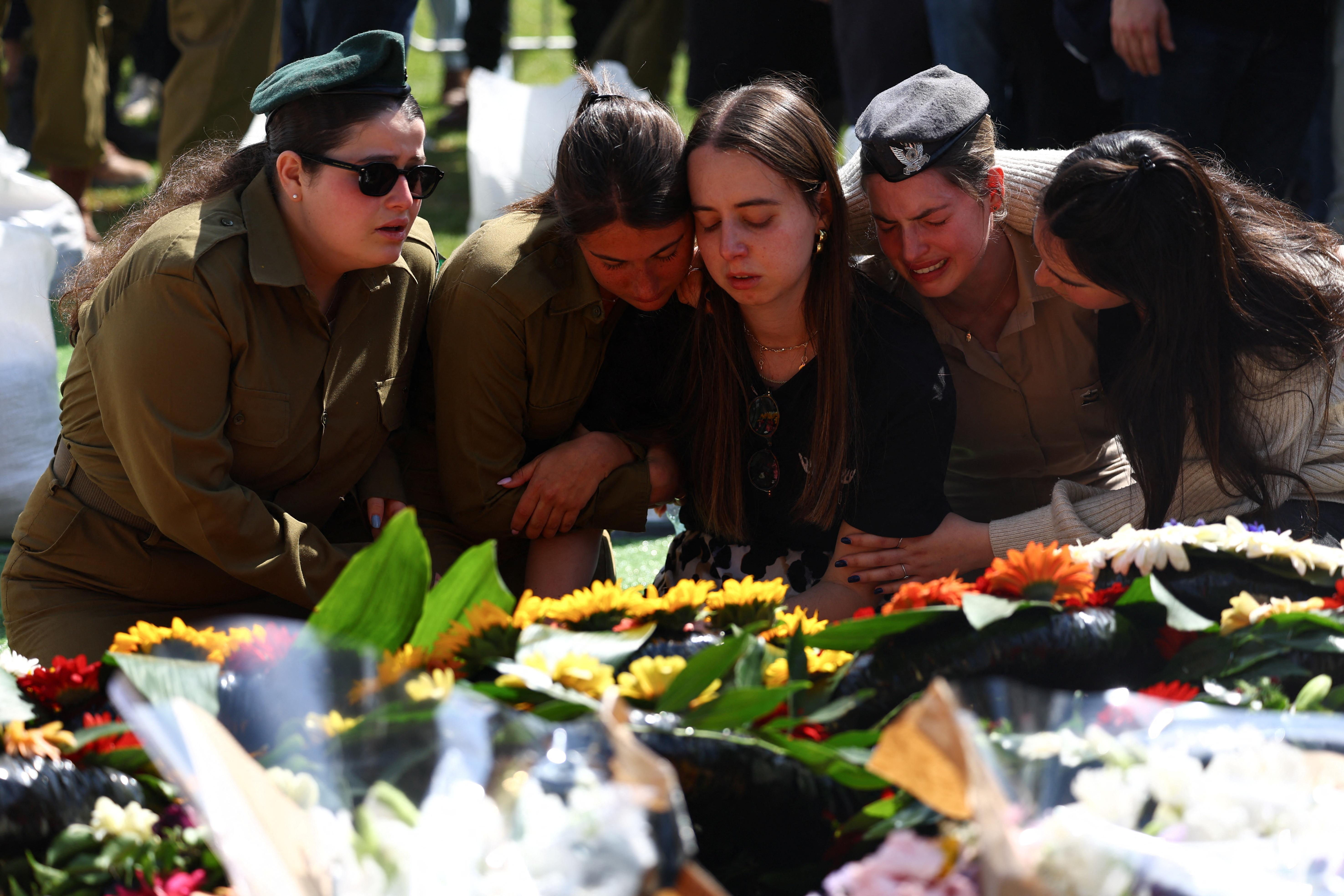 Friends and family mourn Israeli soldier Sergeant Amitai Even Shoshan at his funeral in Tel Mond