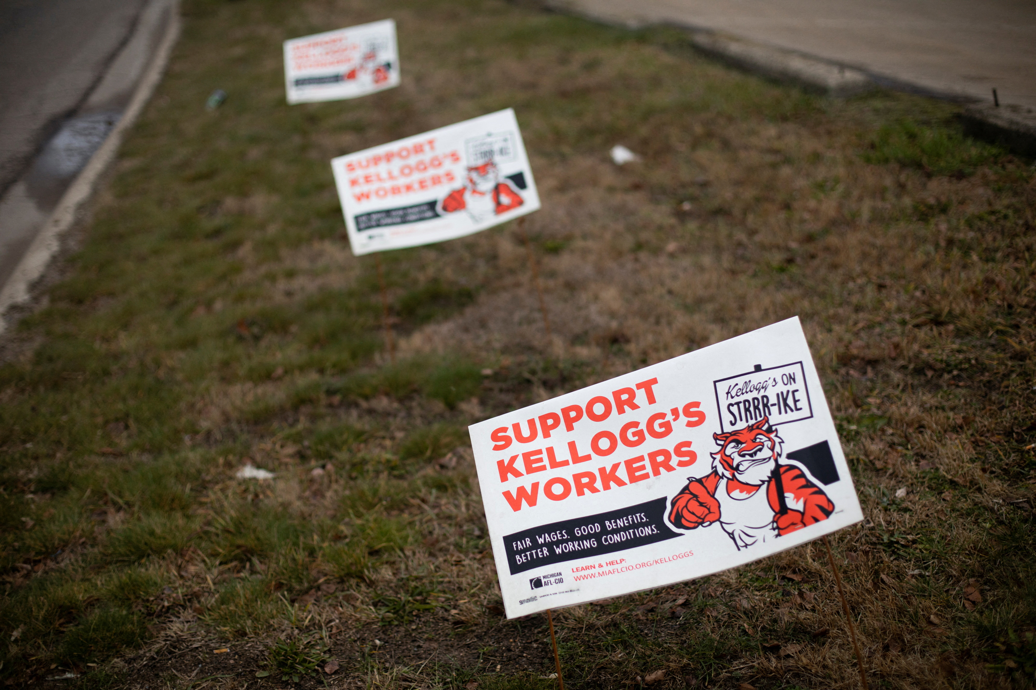 Striking Kellogg workers picket outside a plant in Michigan