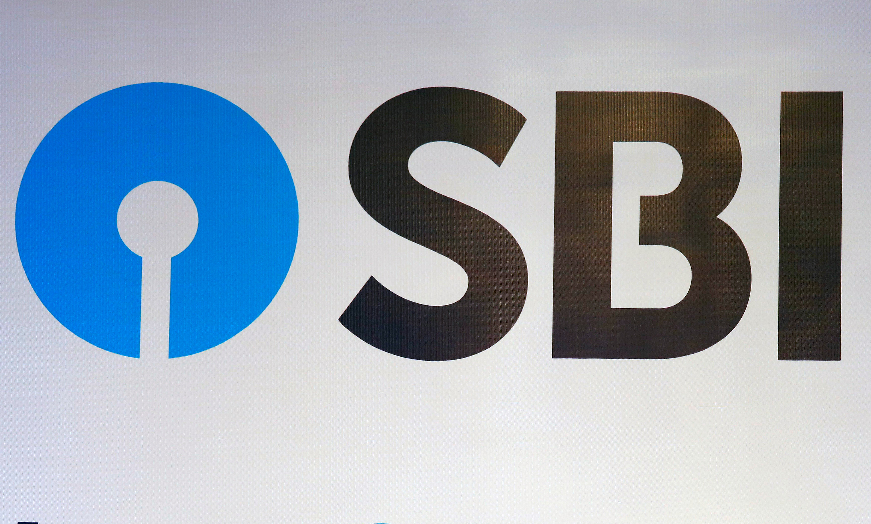 The new logo of State Bank of India (SBI) is pictured at the podium of the venue of a news conference after the announcement of SBI's fourth quarter results, in Kolkata
